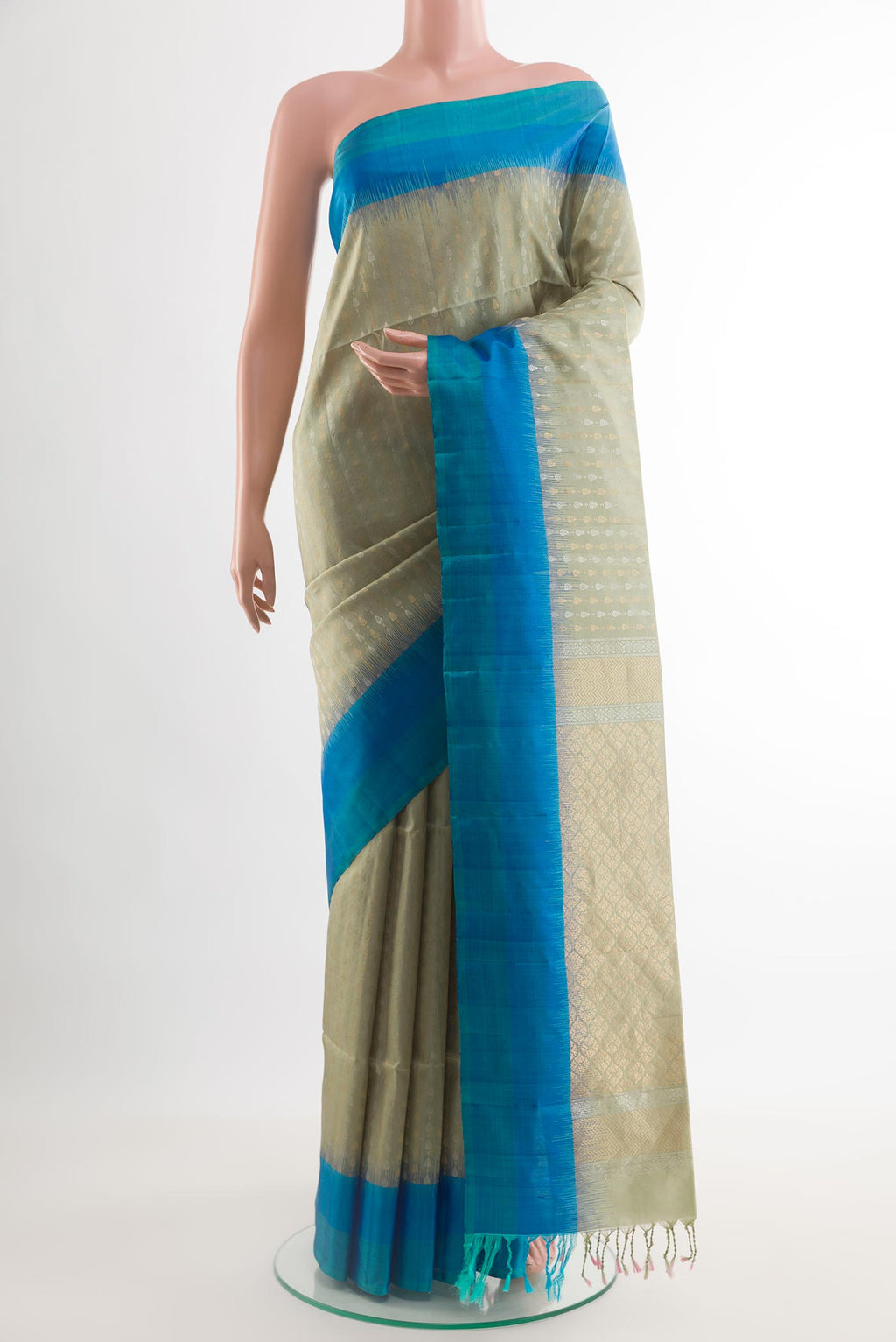 Sage Green Soft Silk Saree with Zari Butta on the body and Zari Border.  displayed on a mannequin