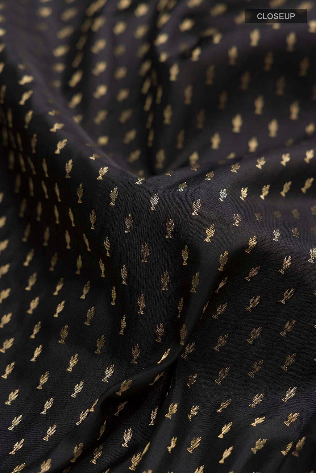 Close up of Black Soft Silk Saree with Zari Butta on the body and Zari Border displaying folds