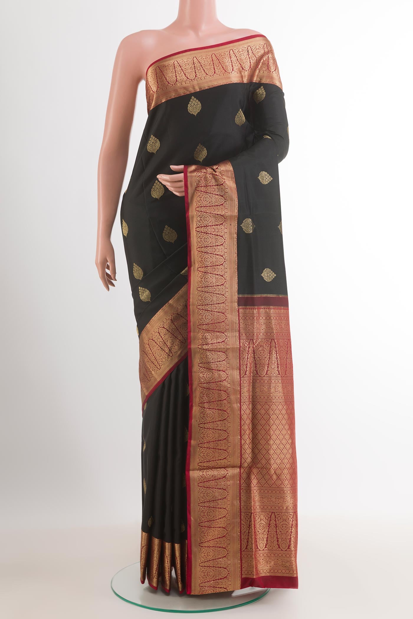 Black Soft Silk Saree with Zari Butta on the body and Zari Border.  displayed on a mannequin