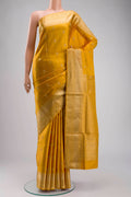 Yellow Soft Silk Saree with Zari Butta on the body and Zari Border displayed on a mannequin