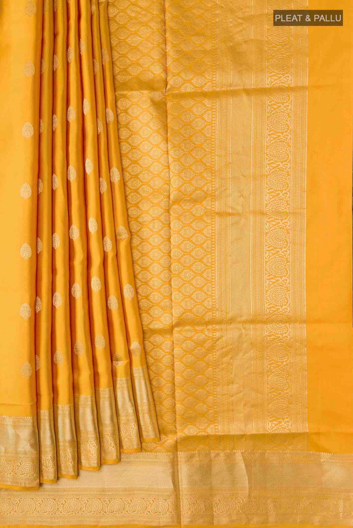 Pleats and pallu of Yellow Soft Silk Saree with Zari Butta on the body and Zari Border