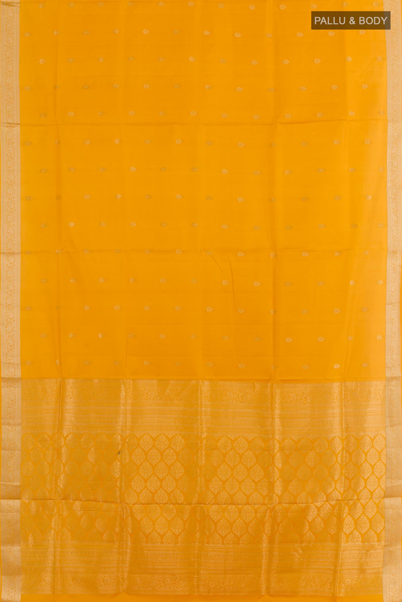 Flat view of Mustard Soft Silk Saree with Zari Butta on the body and Zari Border. 