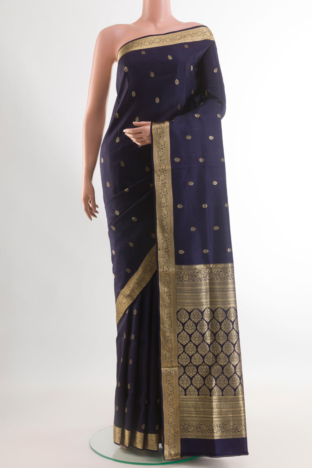 Navy Blue Soft Silk Saree with Zari Butta on the body and Zari Border.  displayed on a mannequin