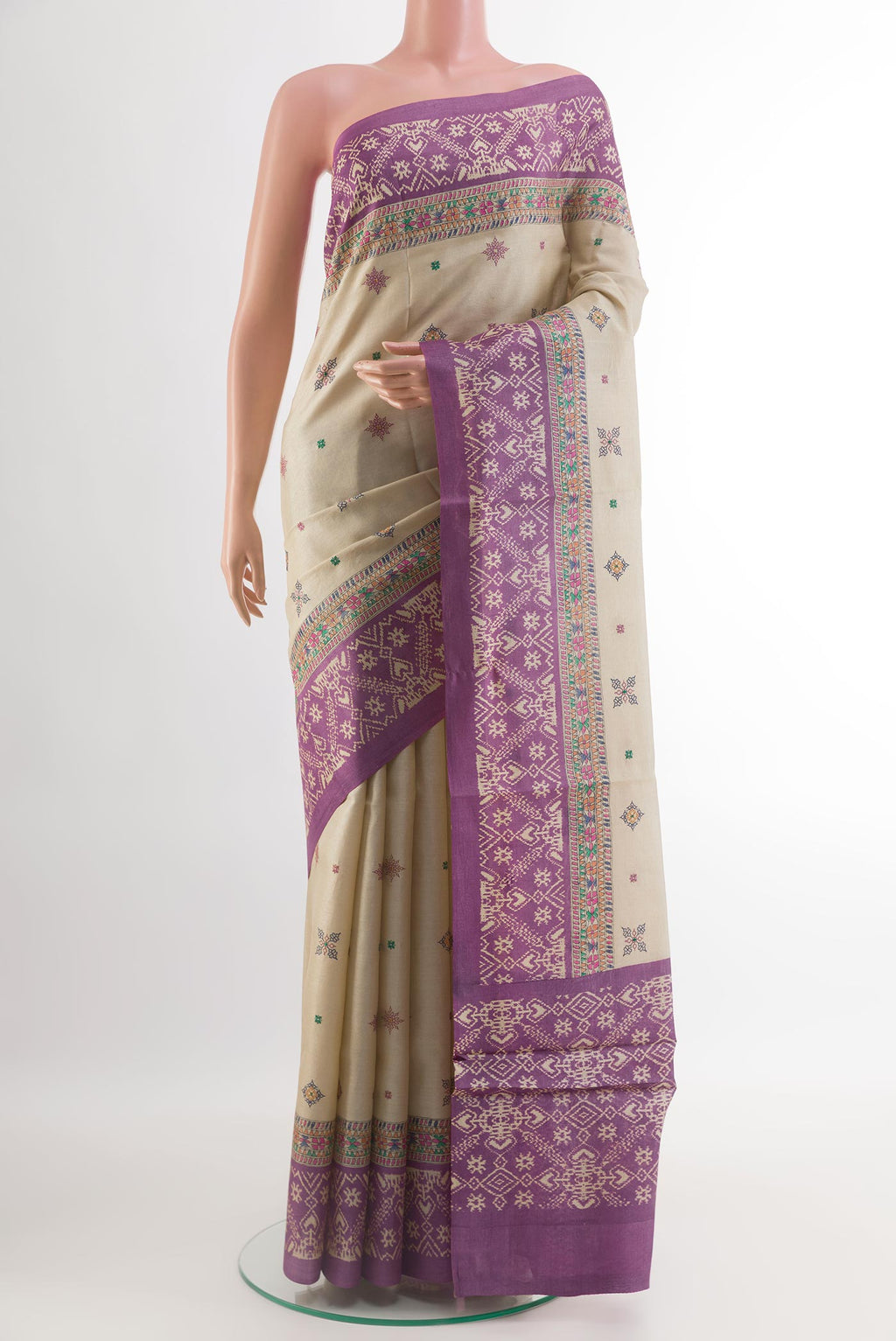 Off White Tussar Silk Saree with Embroidery on the body and Printed Border.  displayed on a mannequin