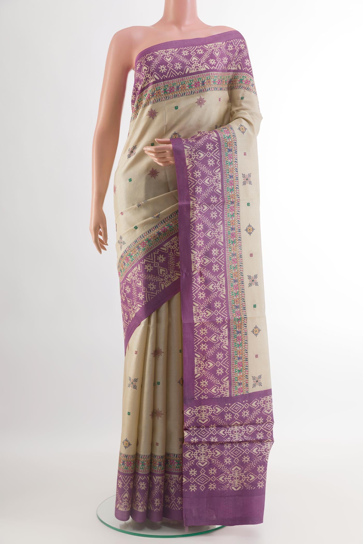 Off White Tussar Silk Saree with Embroidery on the body and Printed Border.  displayed on a mannequin
