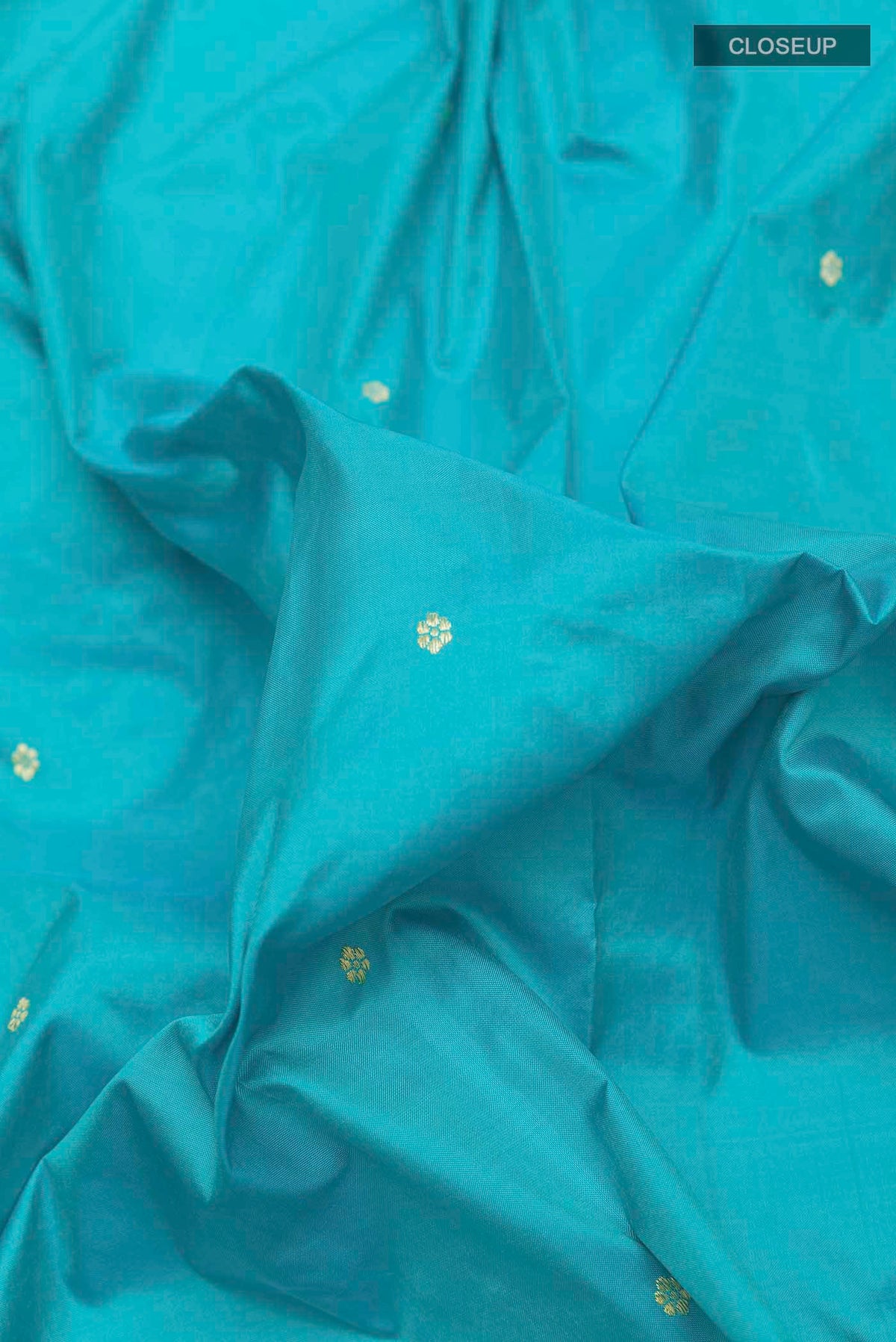 Close up of Blue Paithani Silk Saree with Zari Butta on the body and Paithani Border displaying folds