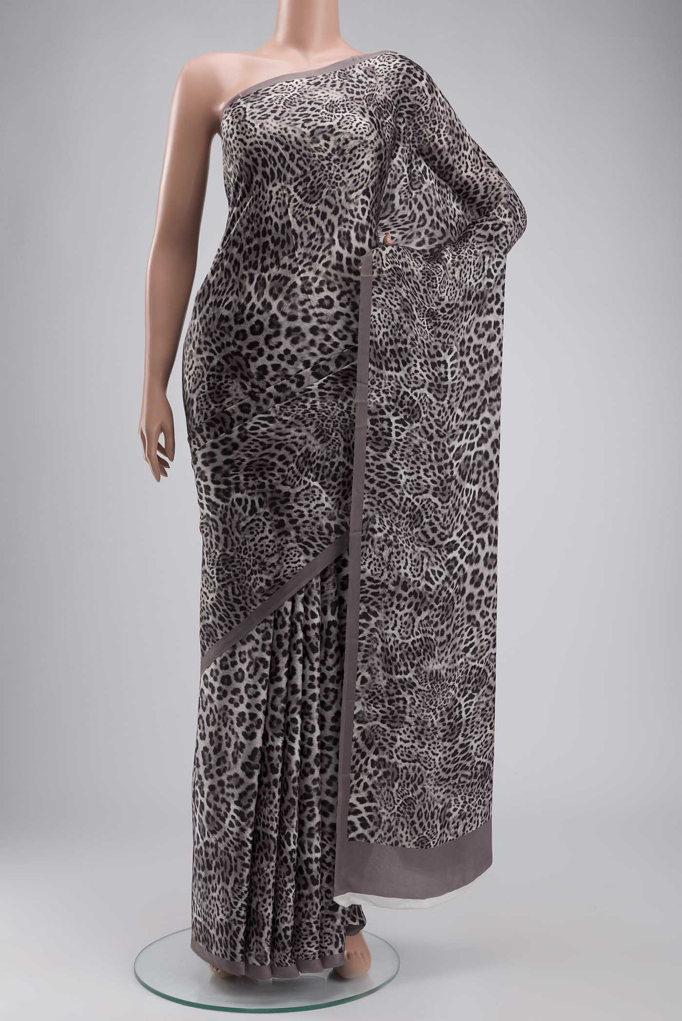 Grey Crepe Saree with Printed design on the body and Plain Border displayed on a mannequin