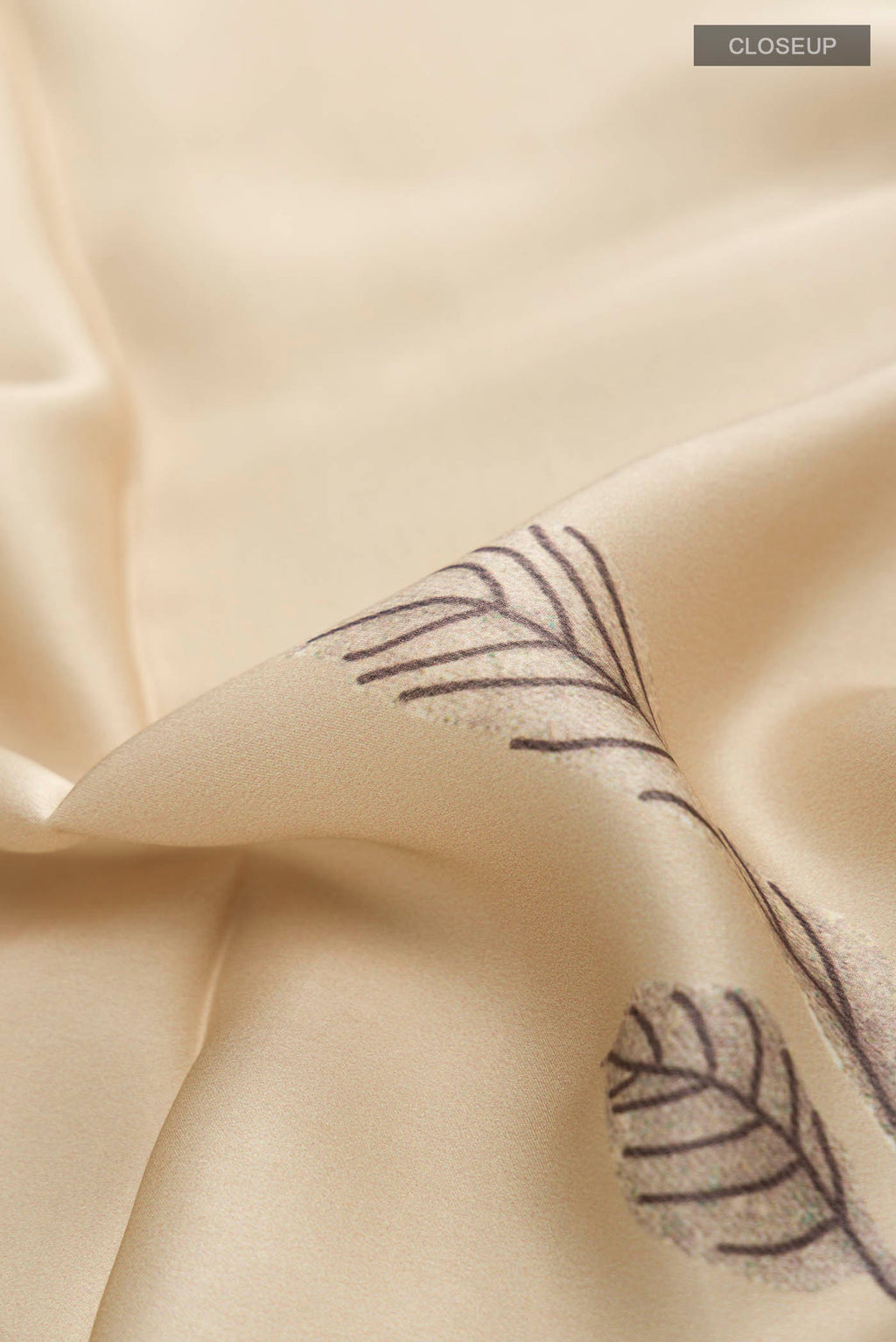 Close up of Beige Satin Silk Saree with Plain Body and Printed Border displaying folds