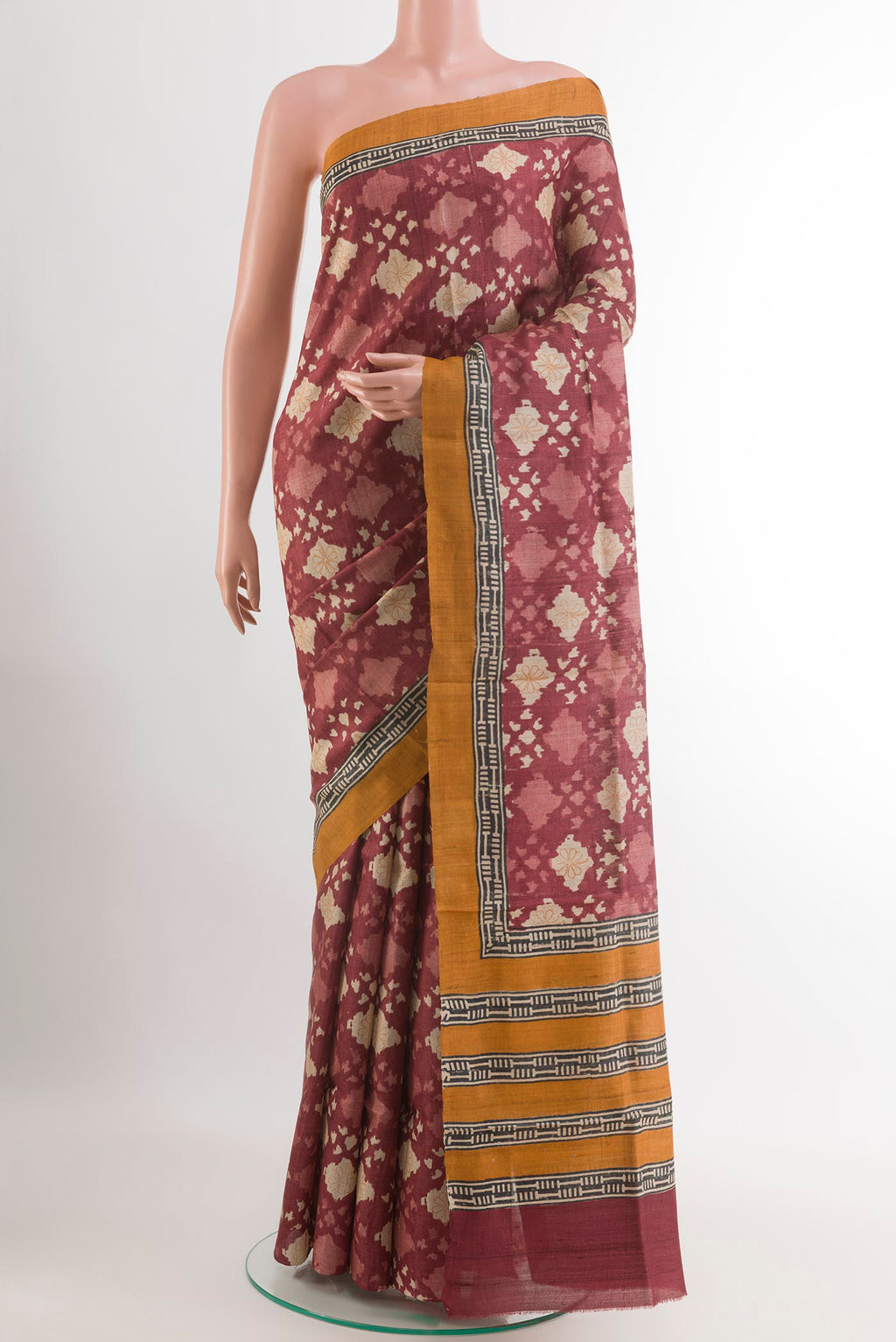 Magenta Tussar Saree with Printed design on the body and Plain Border.  displayed on a mannequin