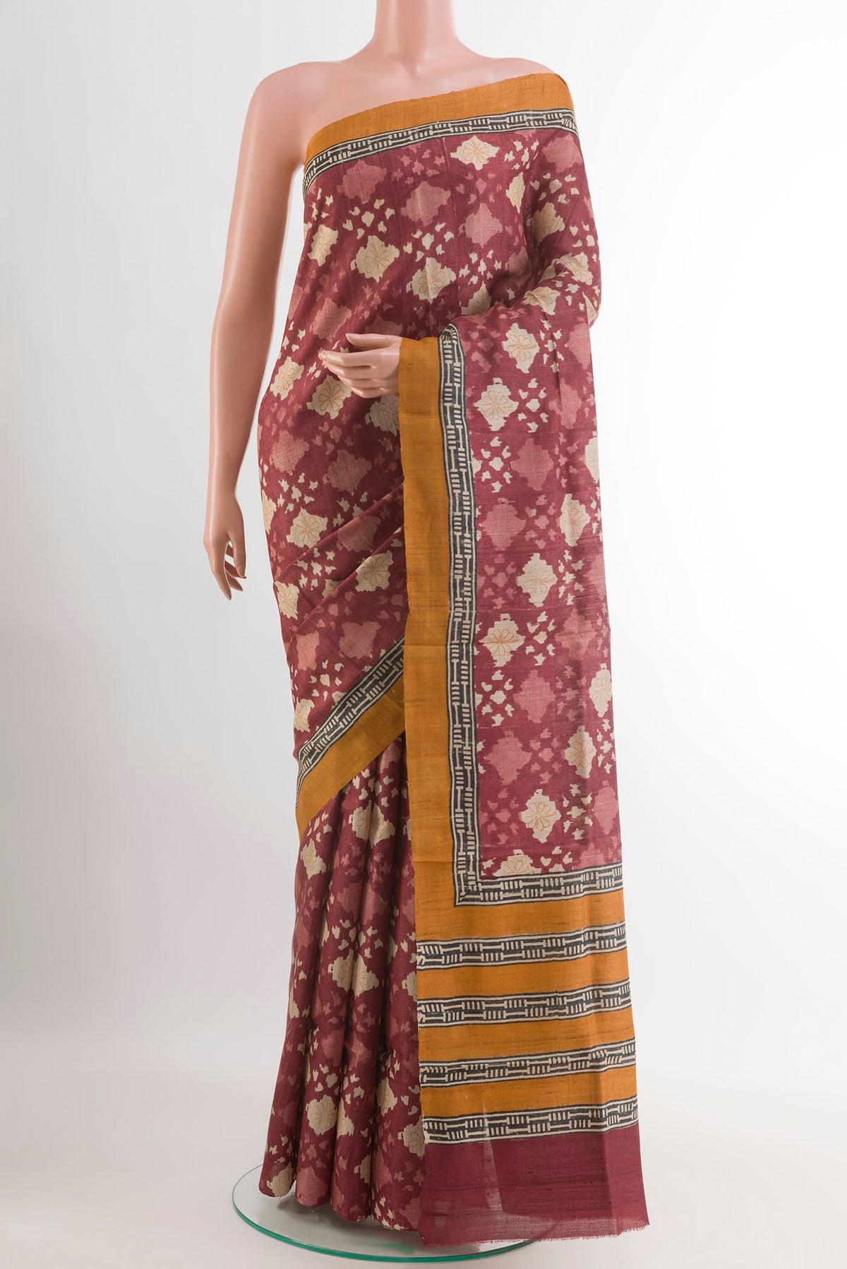 Magenta Tussar Saree with Printed design on the body and Plain Border.  displayed on a mannequin