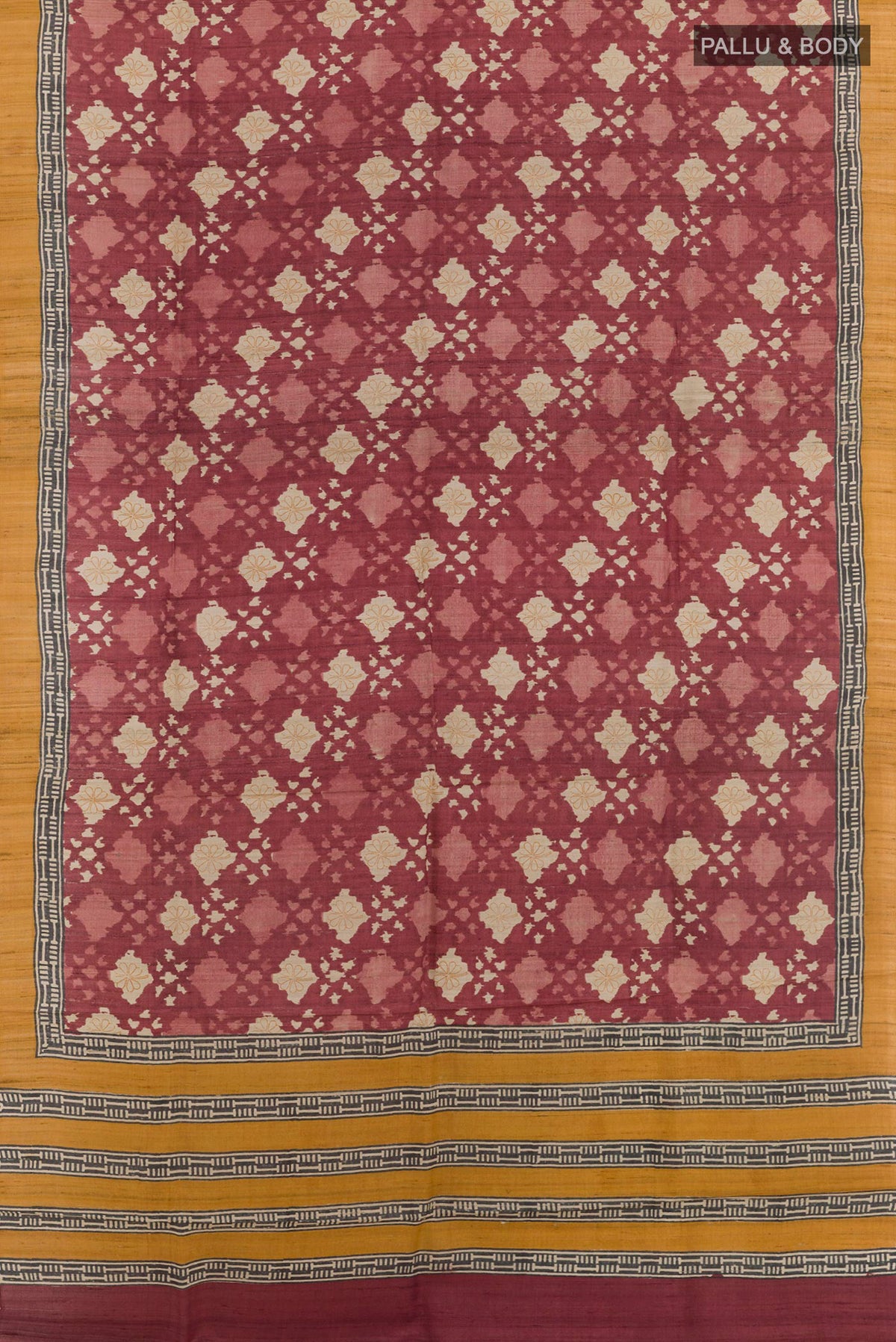 Flat view of Magenta Tussar Saree with Printed design on the body and Plain Border. 