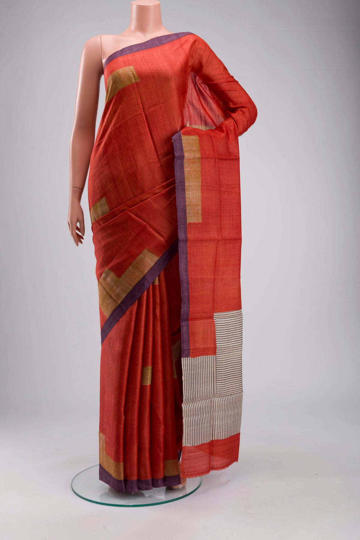 Rust Bhagalpuri Tussar Silk Saree with Printed design on the body and Plain Border displayed on a mannequin