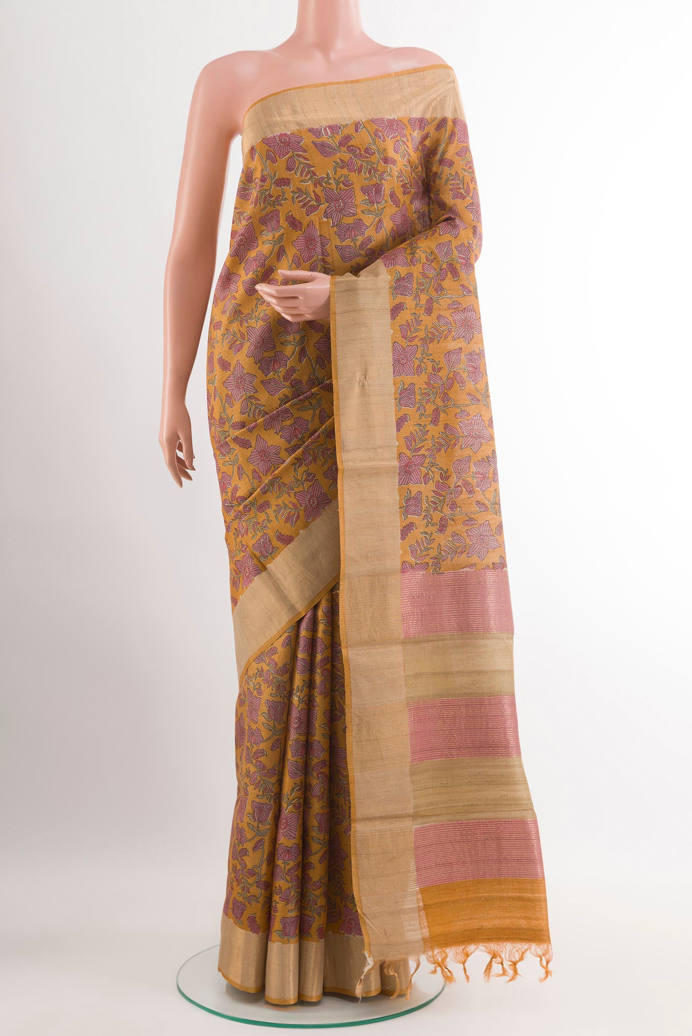 Yellow Tussar Saree with Printed design on the body and Zari Border.  displayed on a mannequin