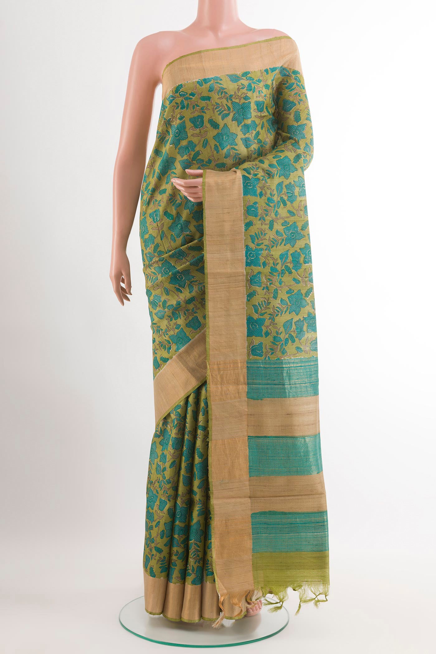 Green Tussar Saree with Printed design on the body and Zari Border.  displayed on a mannequin