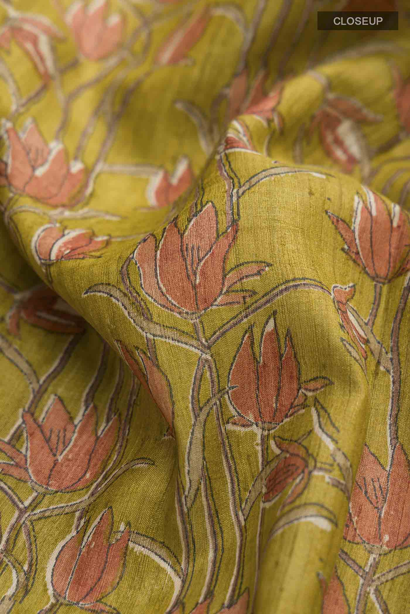 Close up of Green Bhagalpuri Tussar Silk Saree with Printed design on the body and Plain Border displaying folds