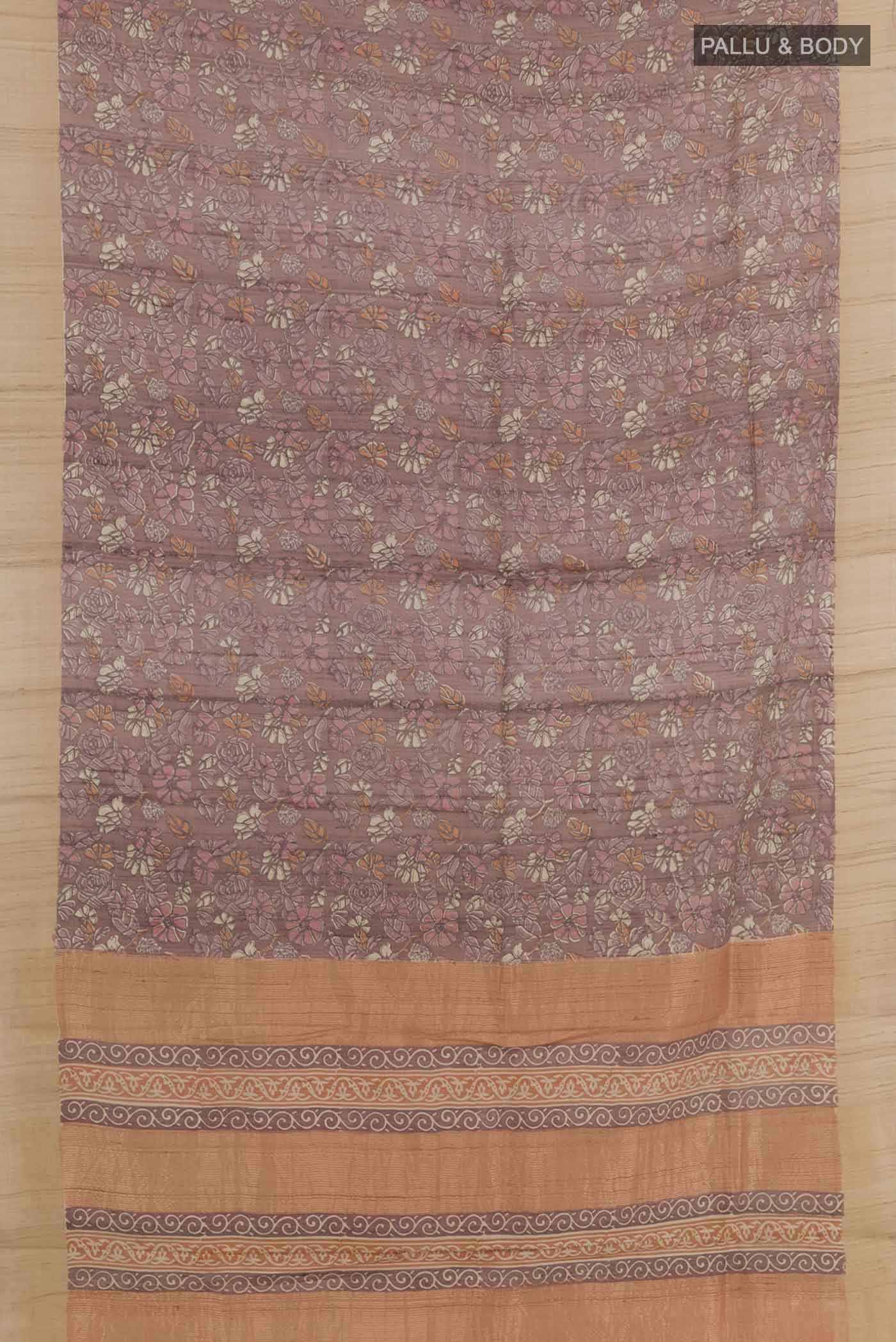Flat view of Pure Silk Pure Zari Purple Tussar Saree with Printed design on the body and Zari Border. 