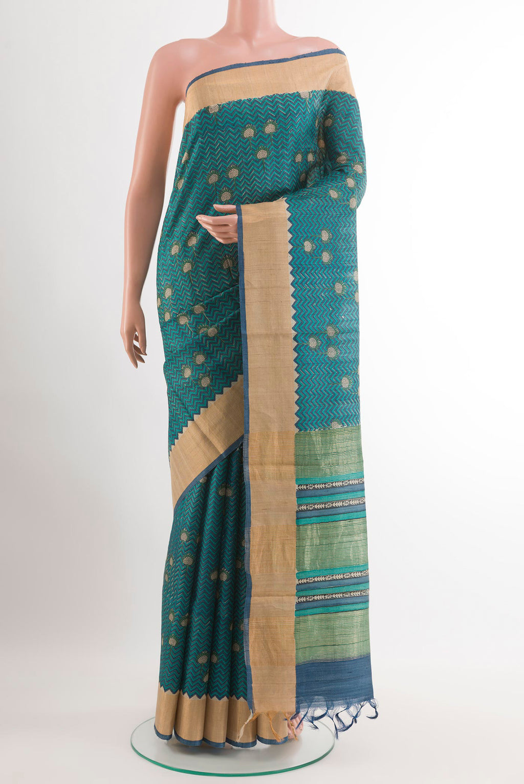 Blue Tussar Saree with Printed design on the body and Zari Border.  displayed on a mannequin
