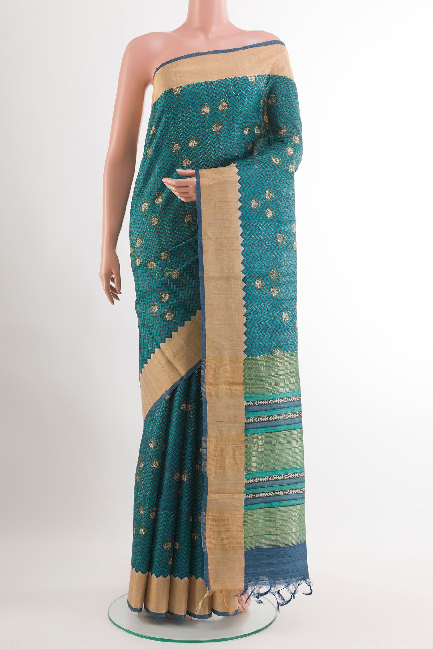 Blue Tussar Saree with Printed design on the body and Zari Border.  displayed on a mannequin