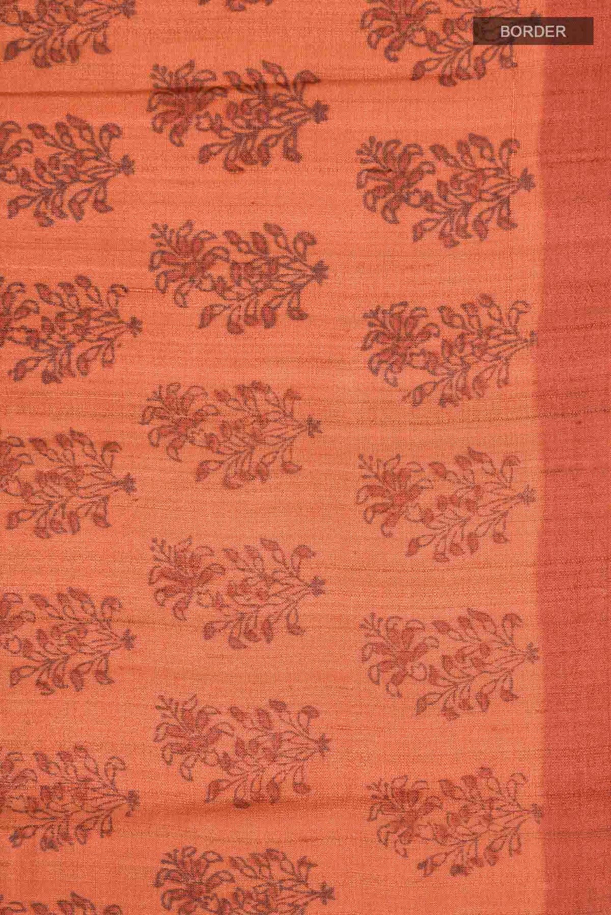 Border image of Orange Tussar Silk Saree with Printed design on the body and Plain Border