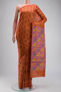 Orange Tussar Silk Saree with Printed design on the body and Plain Border displayed on a mannequin