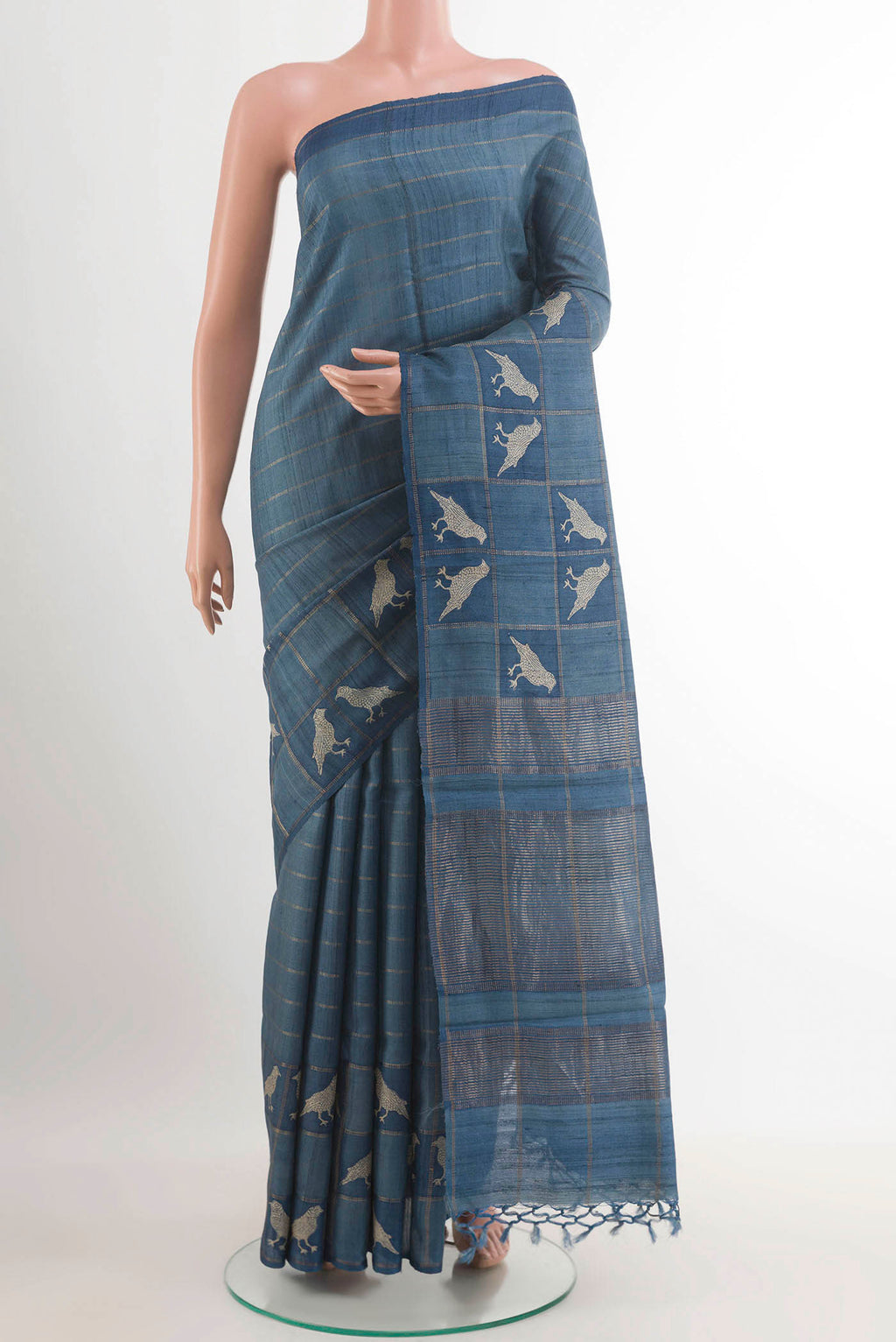 Pure Silk Pure Zari Blue Tussar Saree with Checked design on the body and Zari Border.  displayed on a mannequin