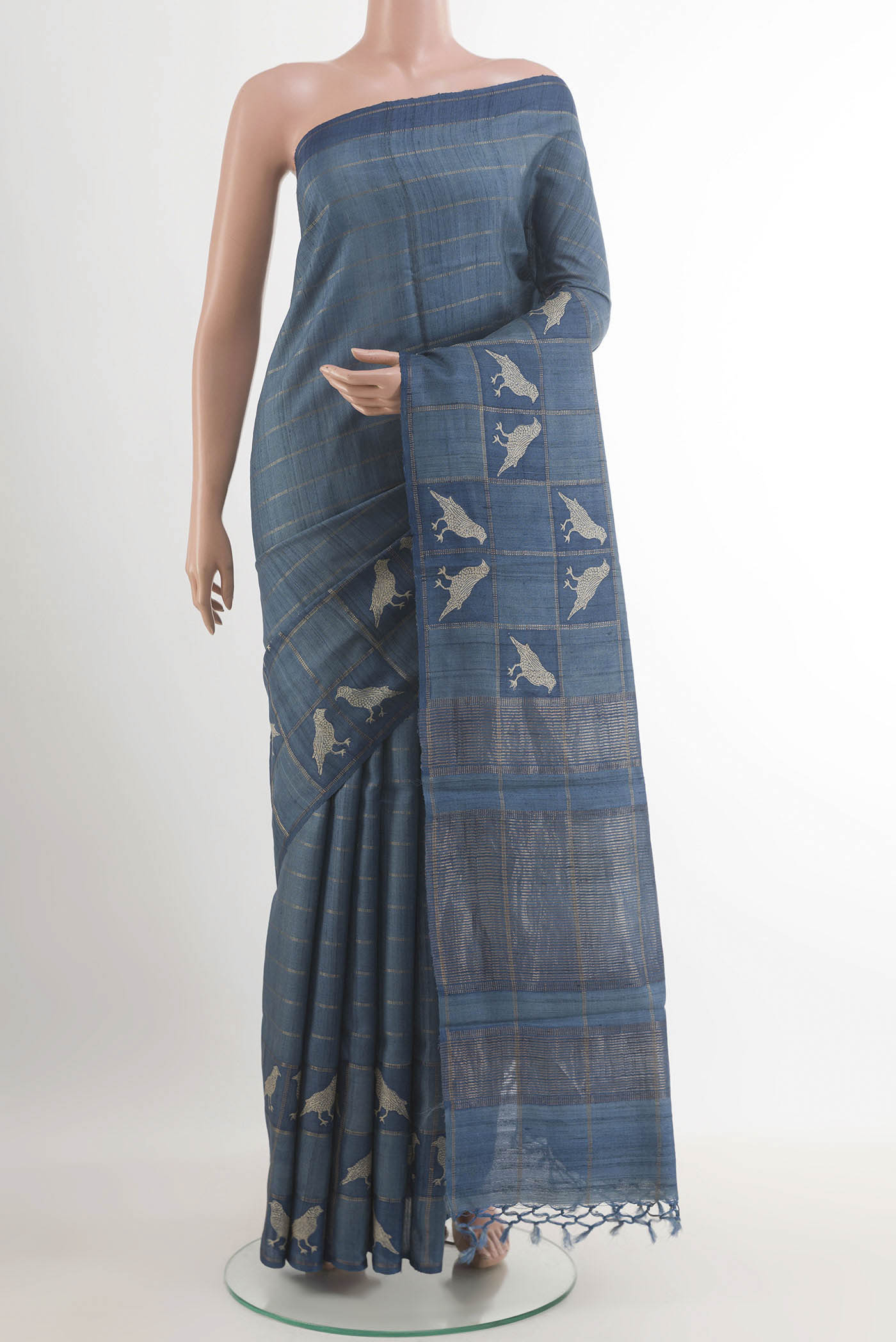 Pure Silk Pure Zari Blue Tussar Saree with Checked design on the body and Zari Border.  displayed on a mannequin