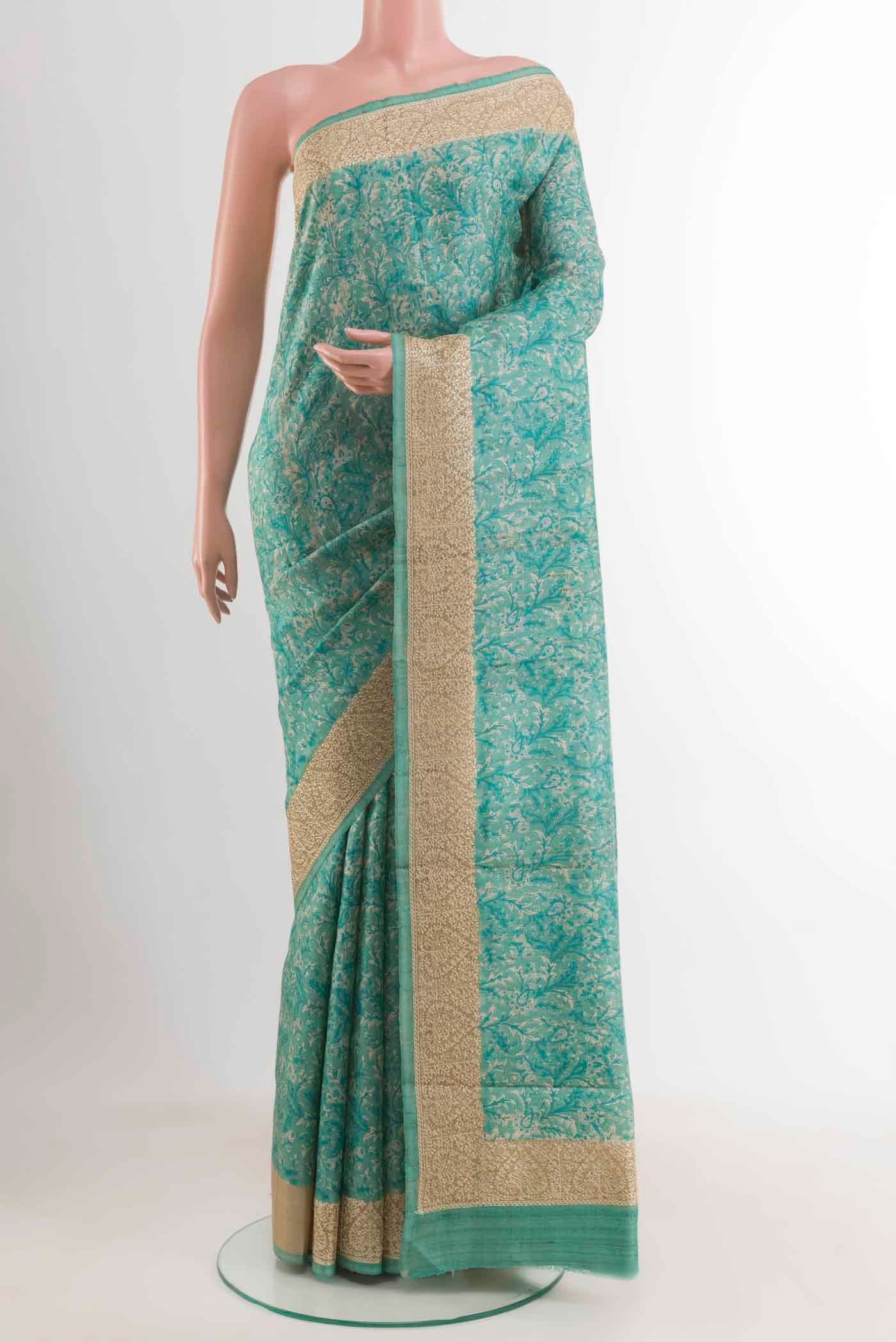 Blue Tussar Saree with Printed design on the body and Embroidery Border displayed on a mannequin