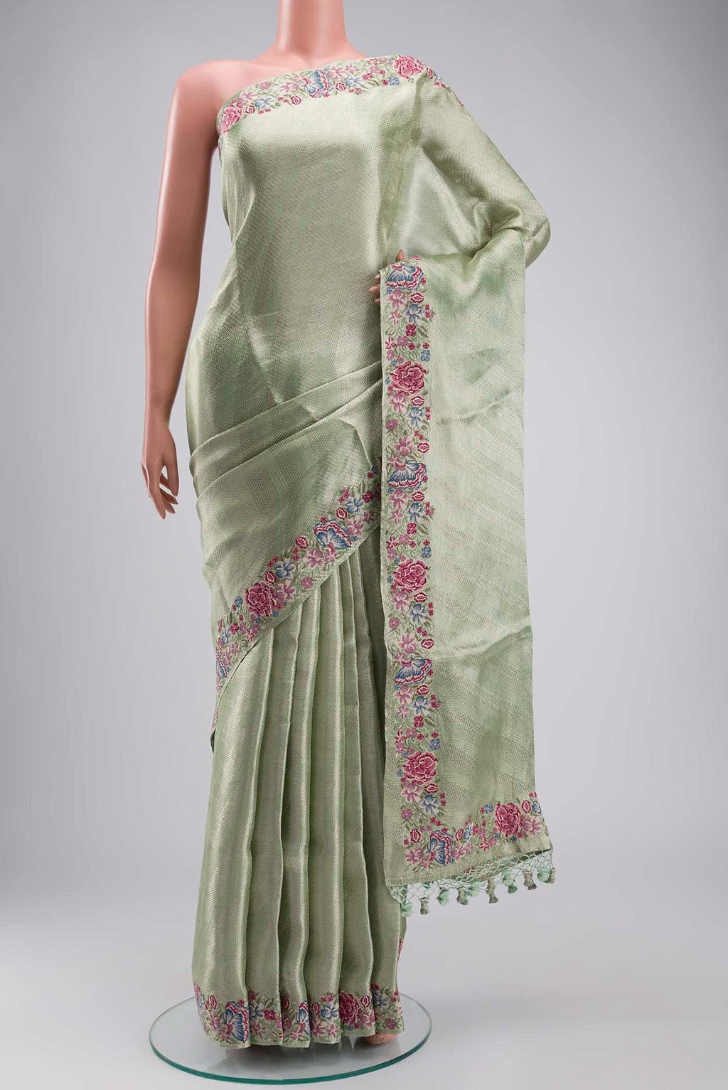 Mint Green Tissue Silk Saree with Zari Brocade on the body and Embroidery Border displayed on a mannequin