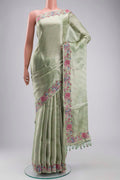 Mint Green Tissue Silk Saree with Zari Brocade on the body and Embroidery Border displayed on a mannequin