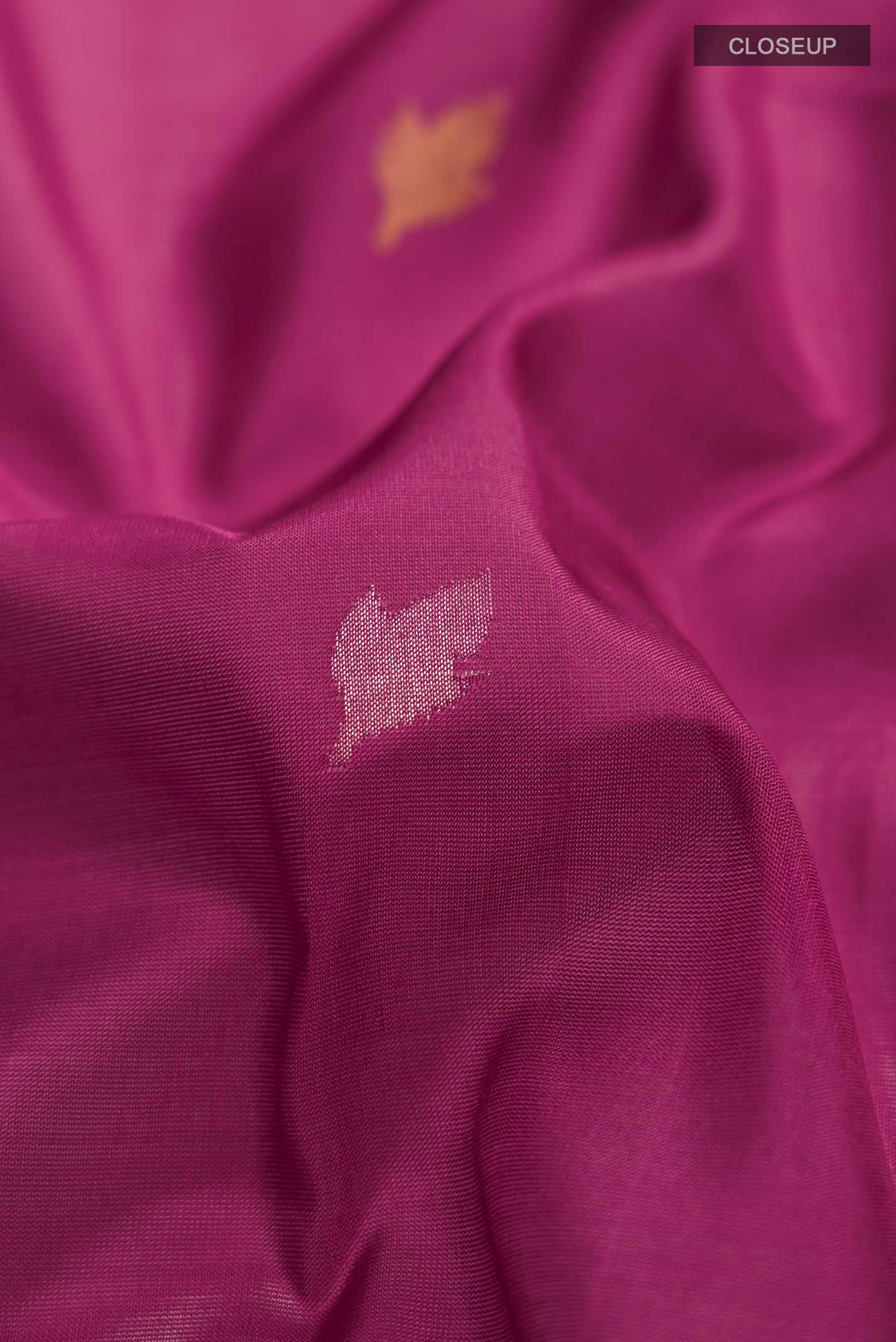 Close up of Pink Uppada Silk Saree with Zari Butta on the body and Zari Border displaying folds