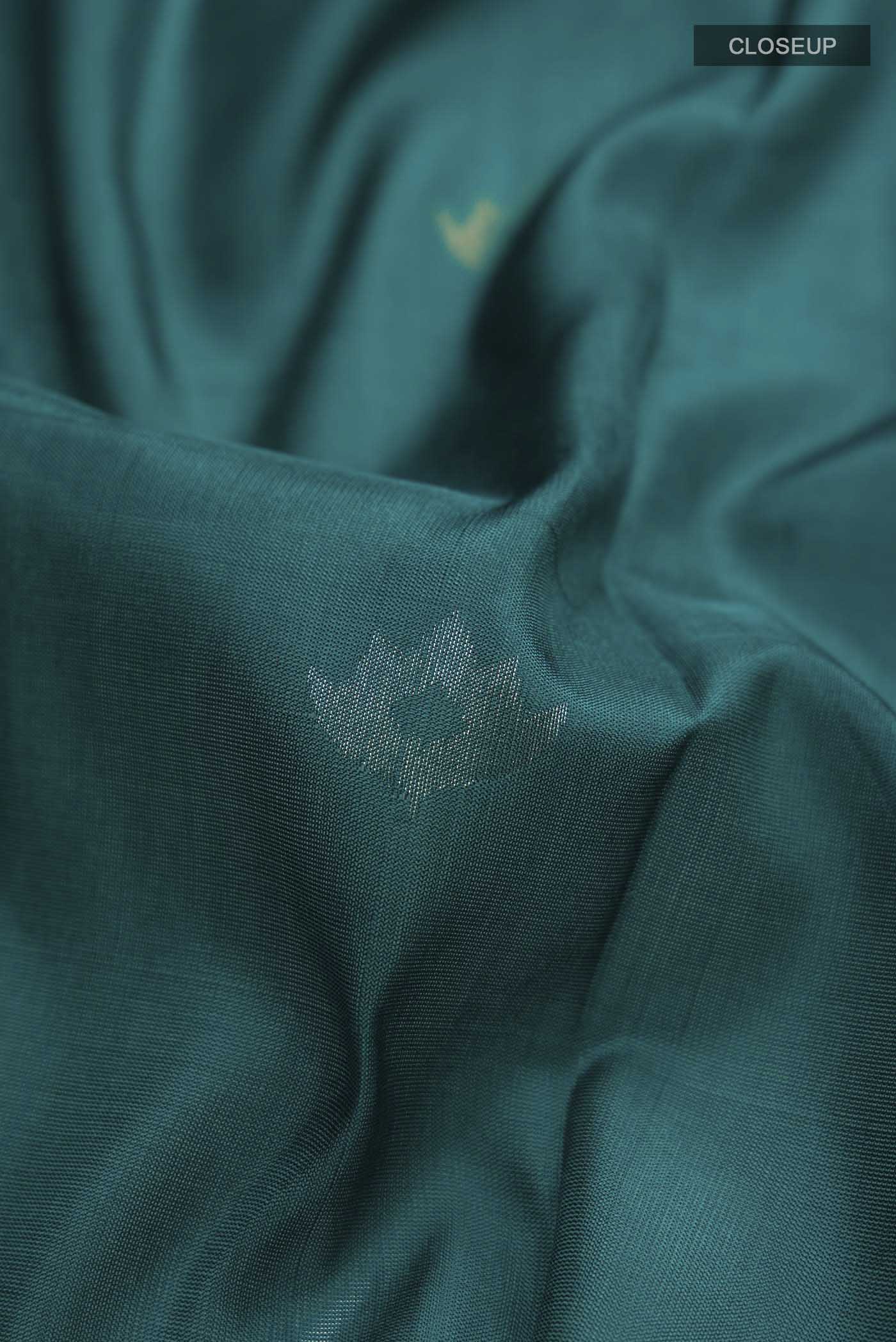 Close up of Blue Uppada Silk Saree with Zari Butta on the body and Zari Border displaying folds
