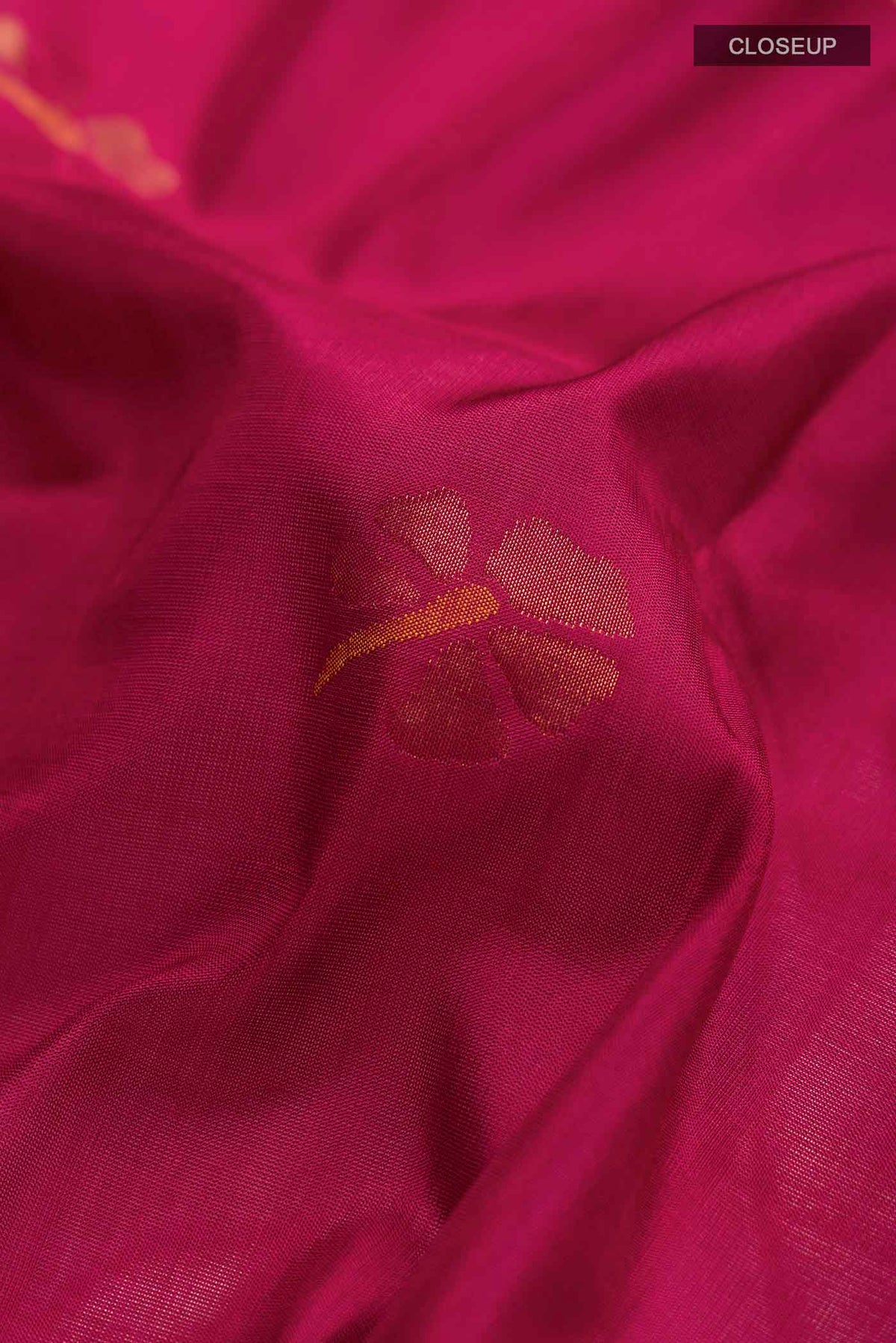 Close up of Maroon Uppada Silk Saree with Zari Butta on the body and Zari Border displaying folds