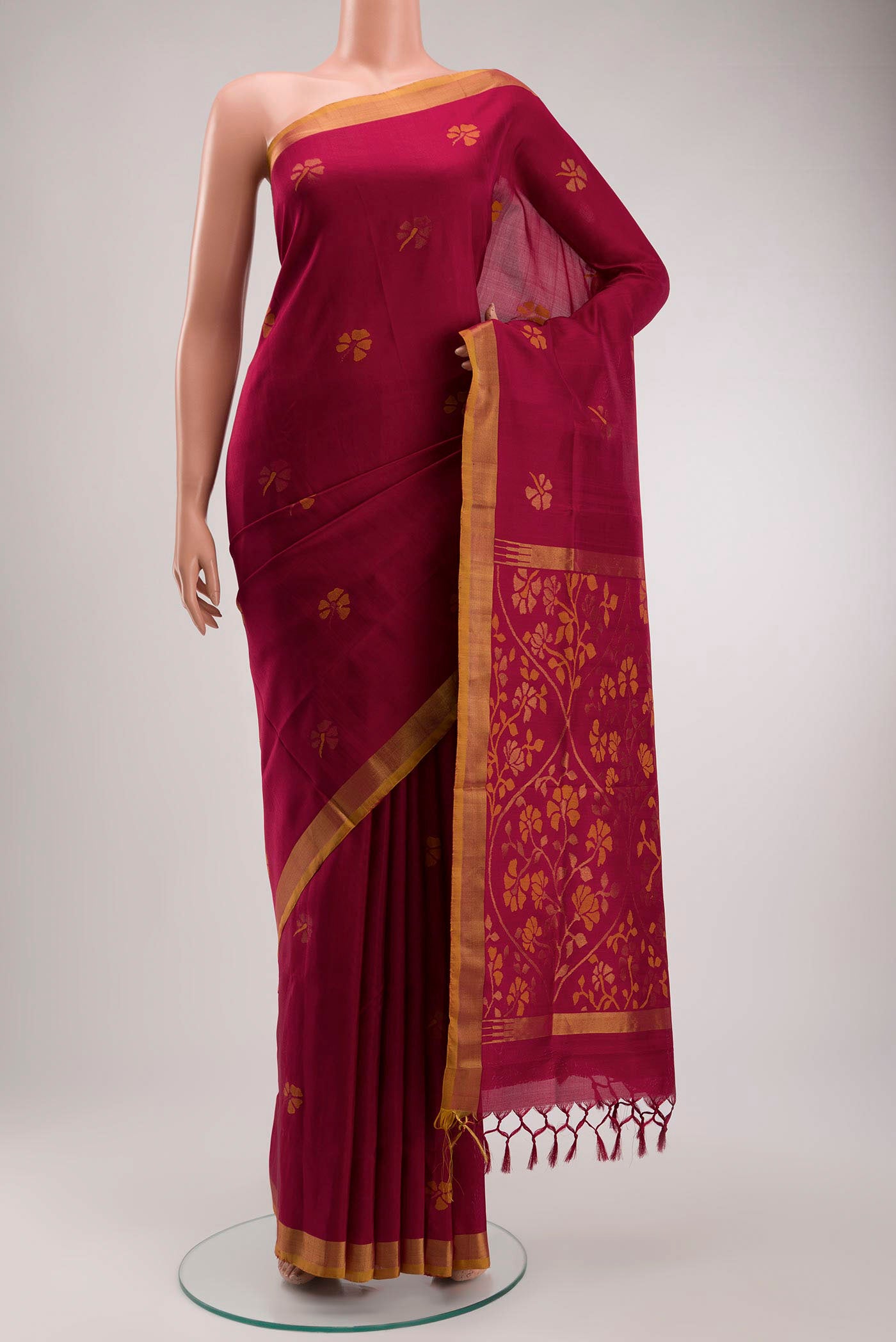 Maroon Uppada Silk Saree with Zari Butta on the body and Zari Border displayed on a mannequin