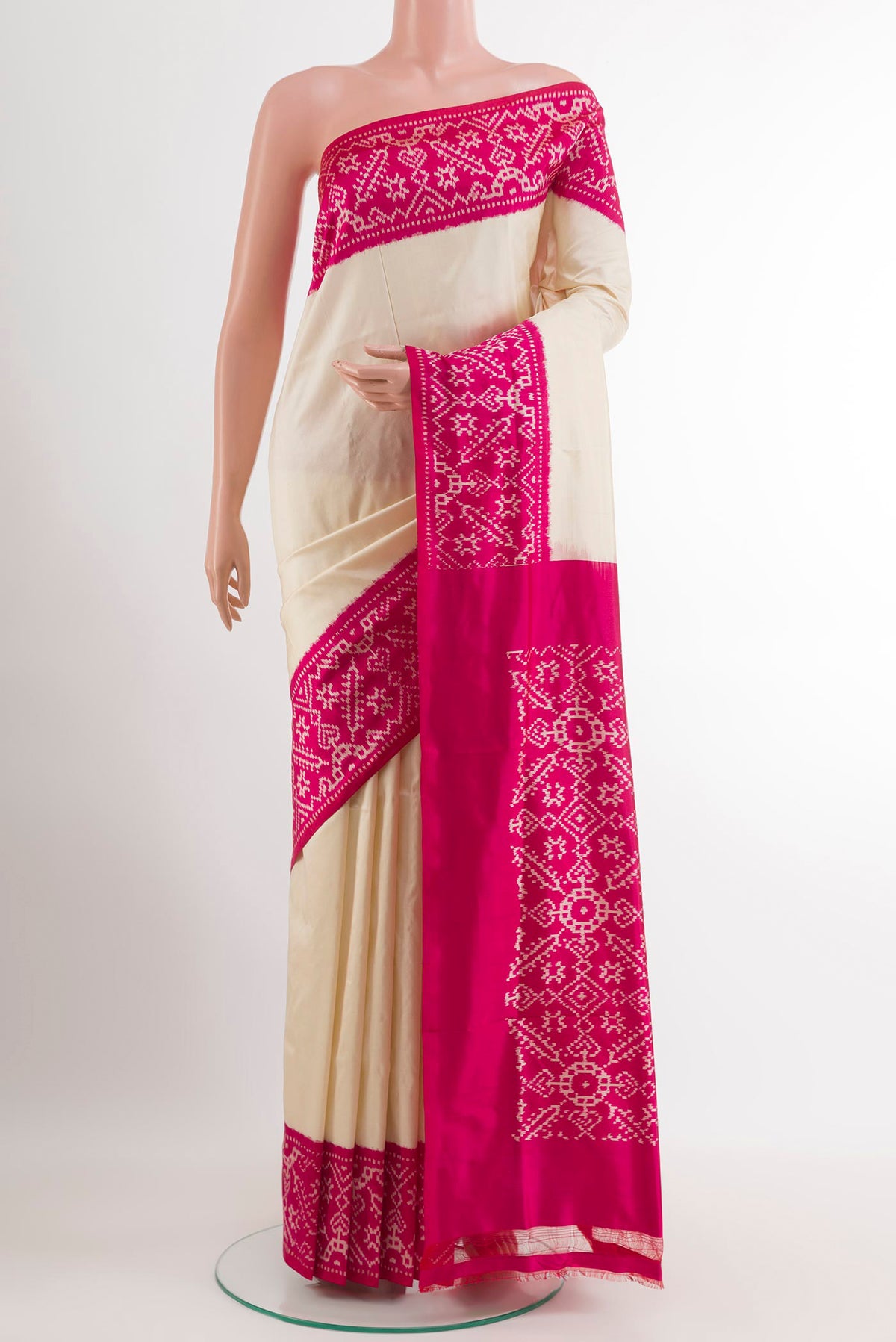Off White Pochampally Silk Saree with Plain Body and Ikat Border.  displayed on a mannequin