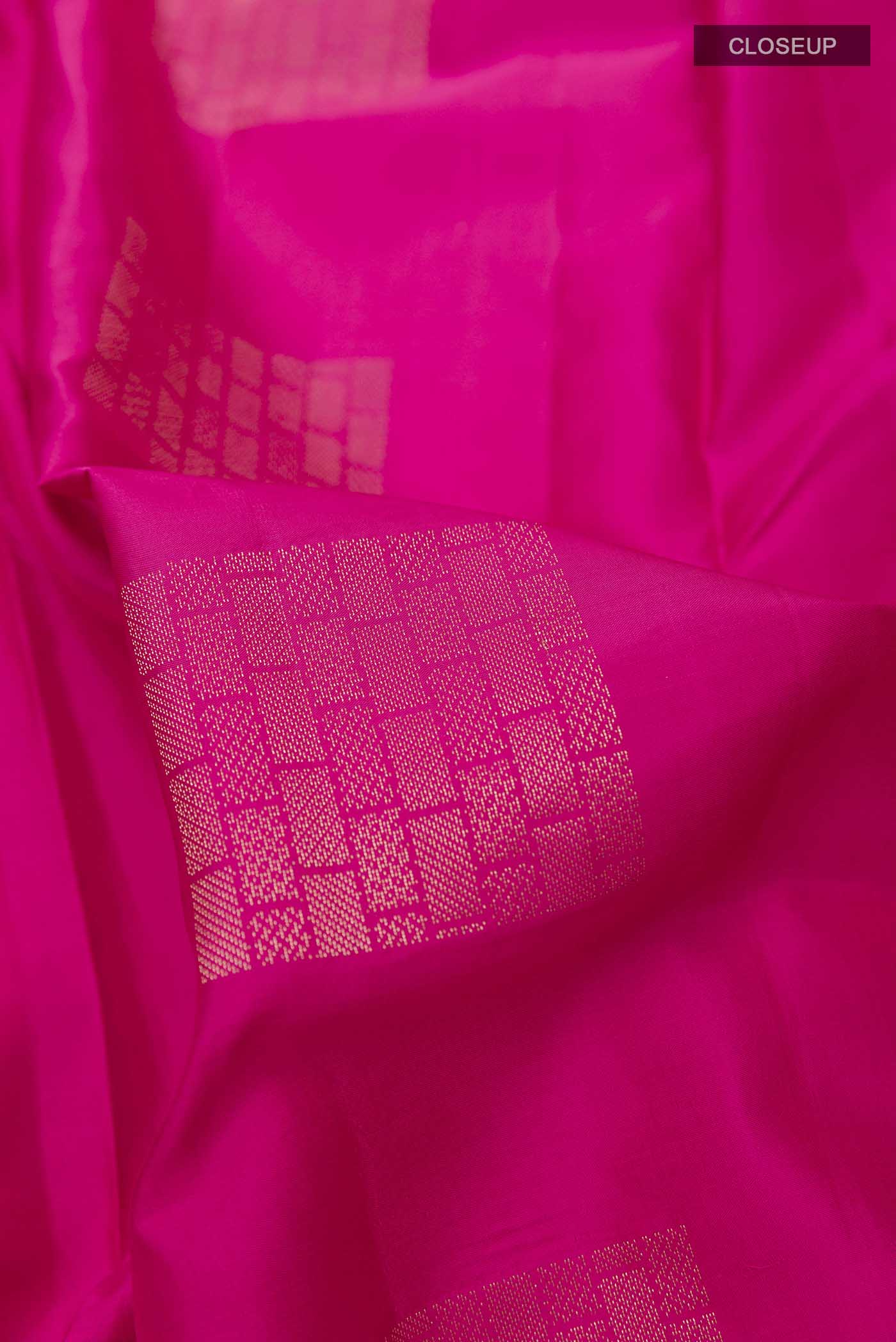 Close up of Pink Soft Silk Saree with Zari Butta on the body and Without Border displaying folds