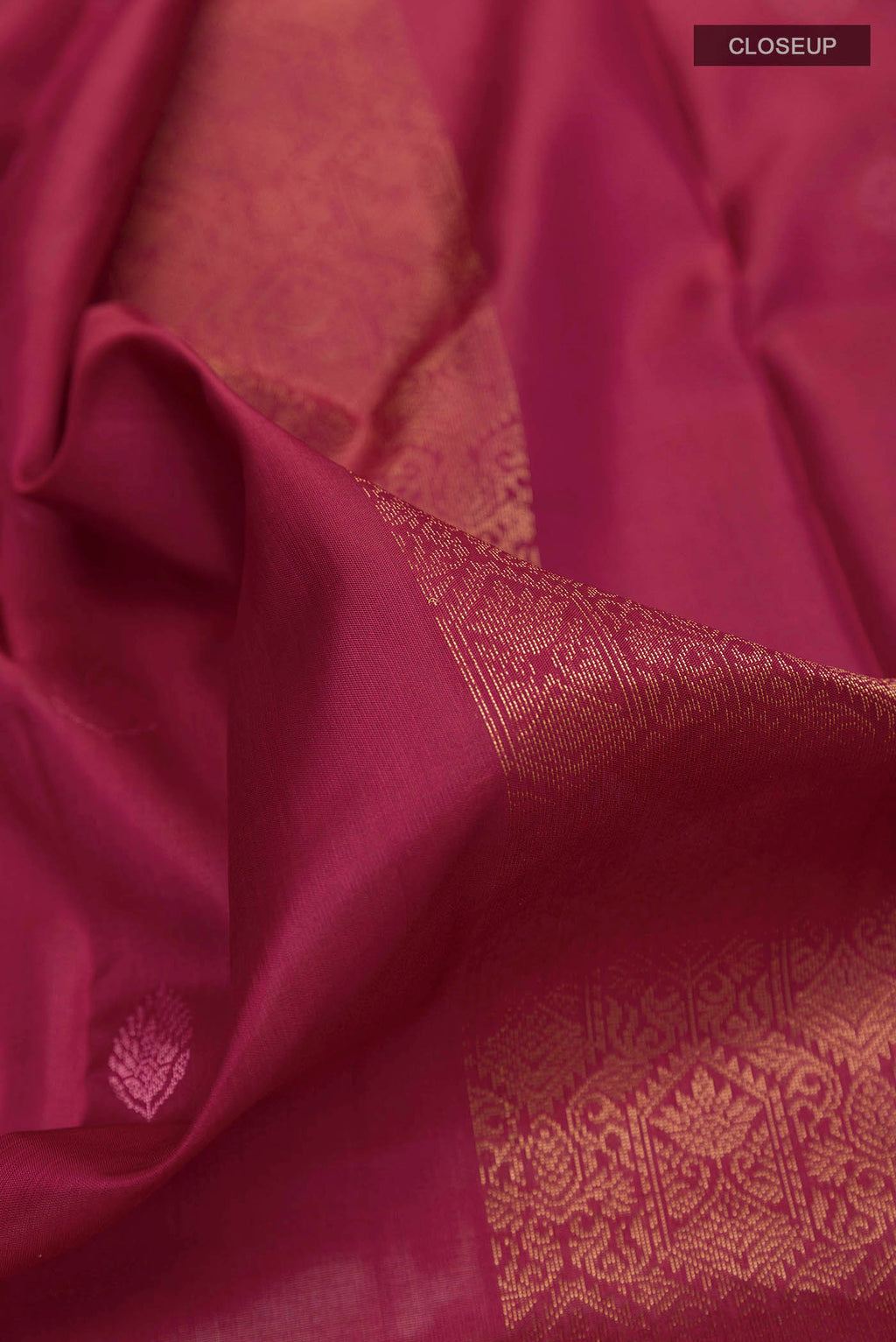 Close up of Maroon Soft Silk Saree with Zari Butta on the body and Without Border displaying folds