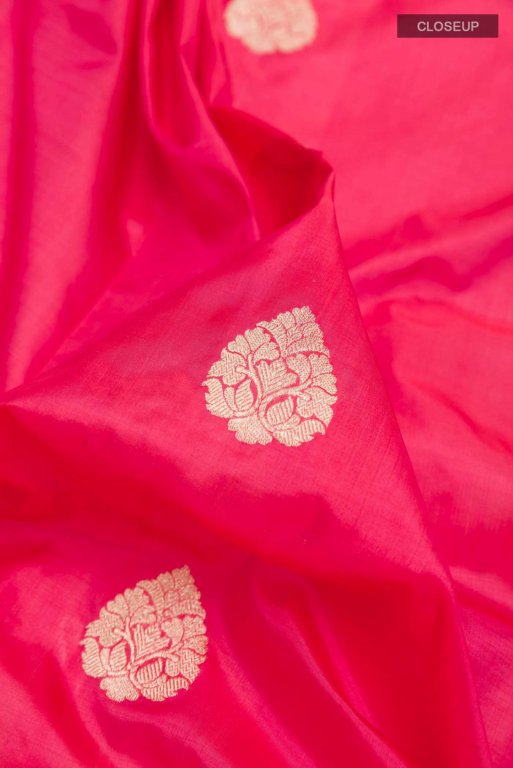Close up of Pink Dual Tone Banarasi Katan Silk Saree with Zari Butta on the body and Zari Border displaying folds