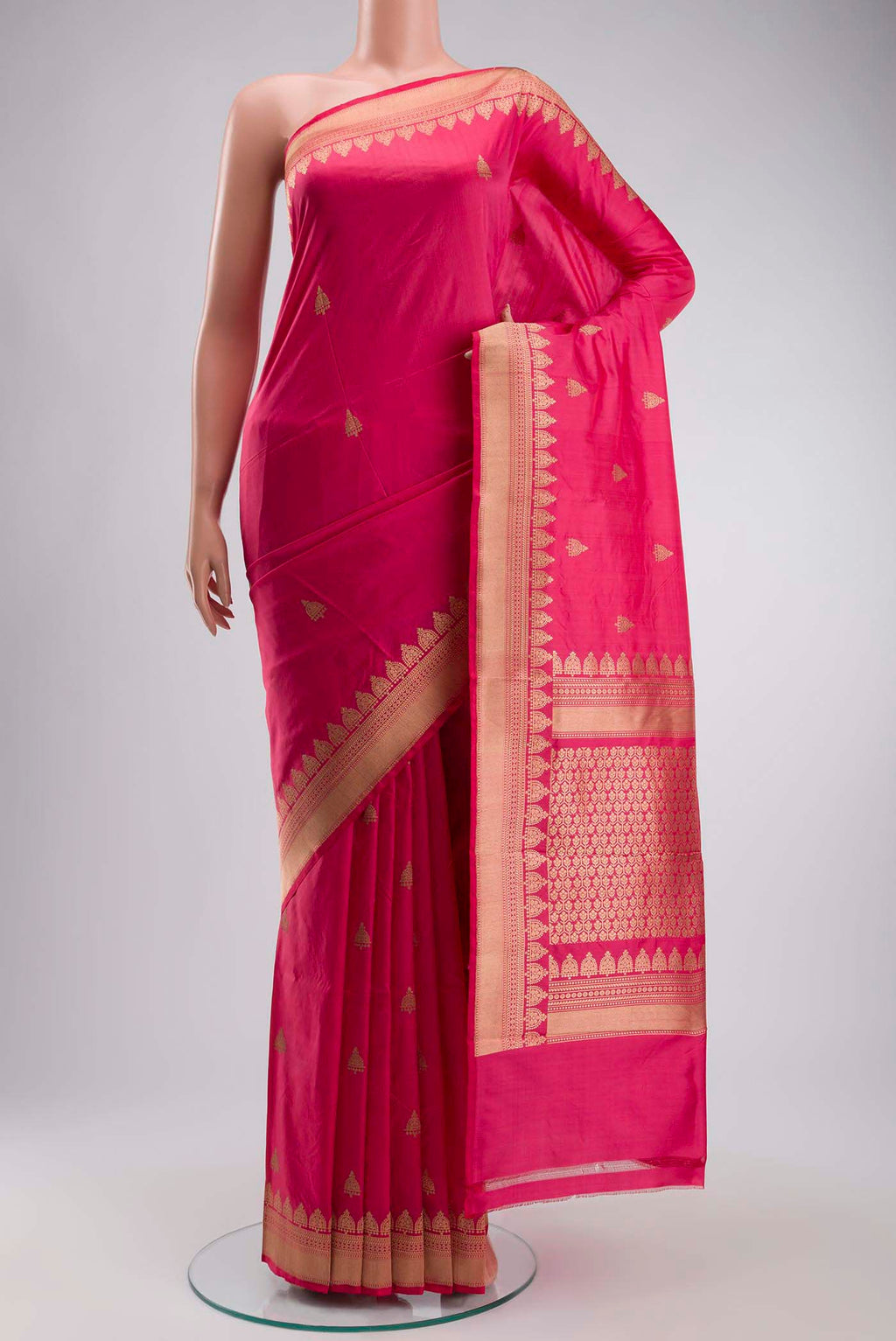 Coral Banarasi Katan Silk Saree with Zari Butta on the body and Zari Border displayed on a mannequin