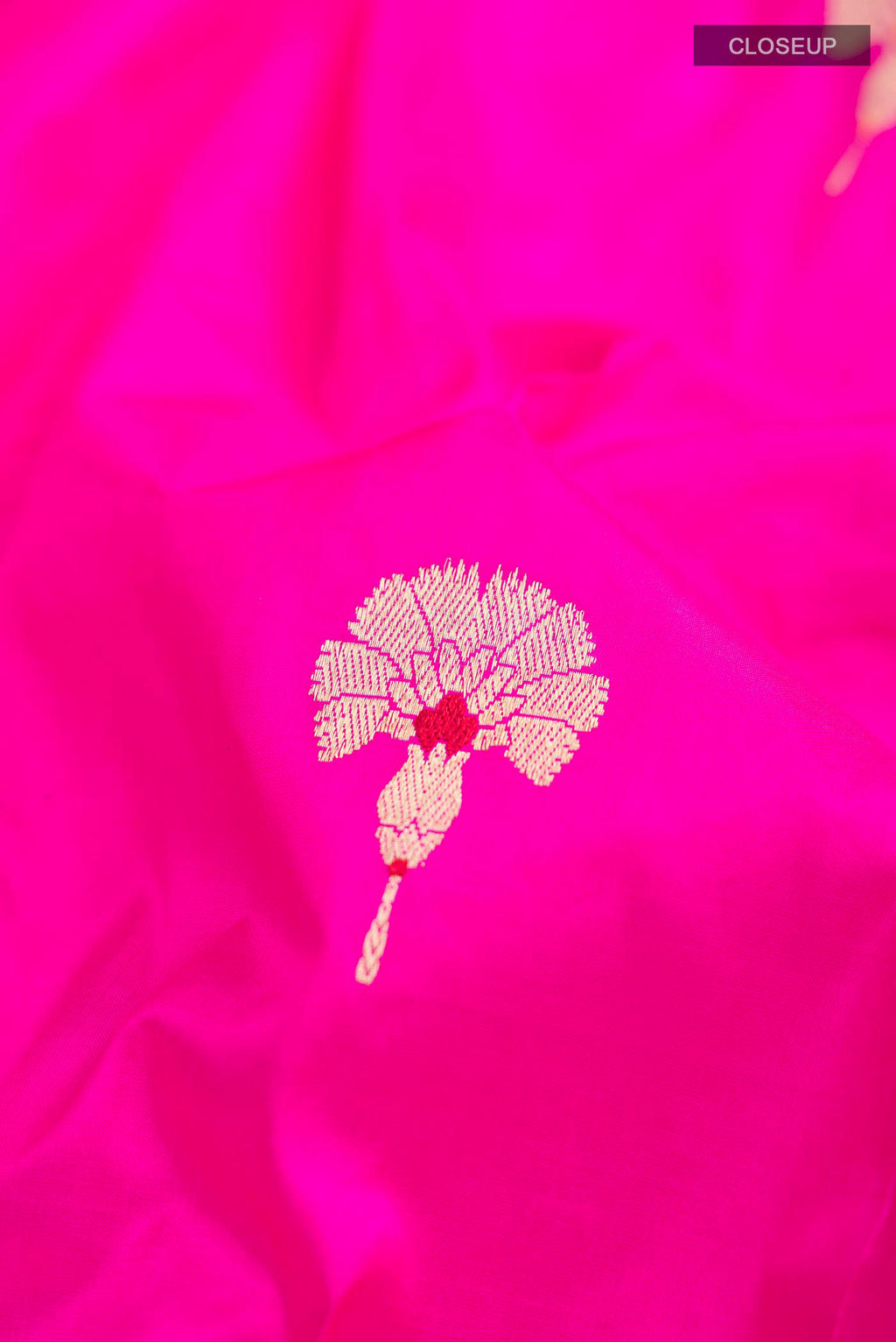 Close up of Rani Pink Banarasi Katan Silk Saree with Zari Butta on the body and Zari Border displaying folds