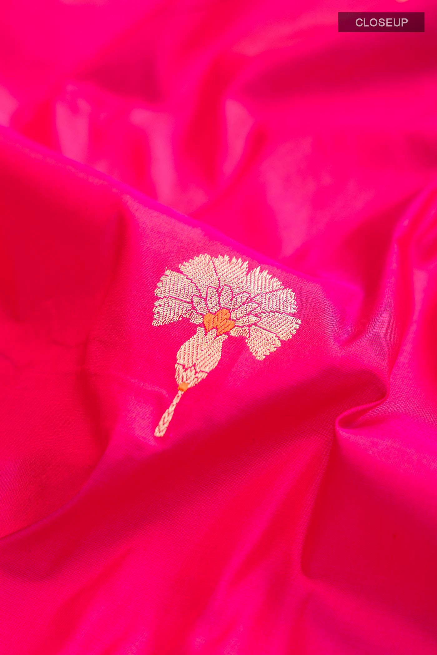 Close up of Pink Banarasi Katan Silk Saree with Zari Butta on the body and Zari Border displaying folds