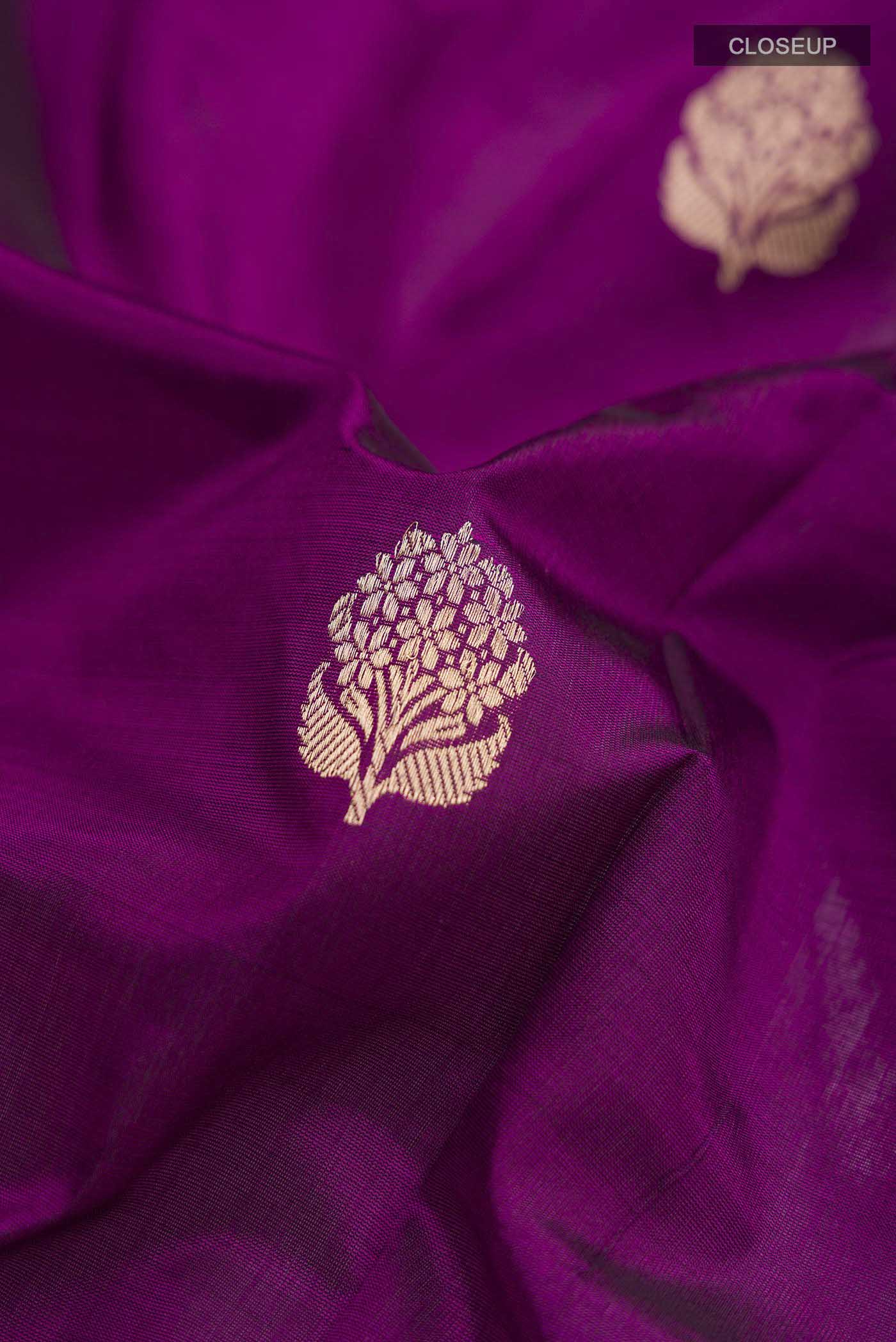 Close up of Violet Banarasi Katan Silk Saree with Zari Butta on the body and Zari Border displaying folds
