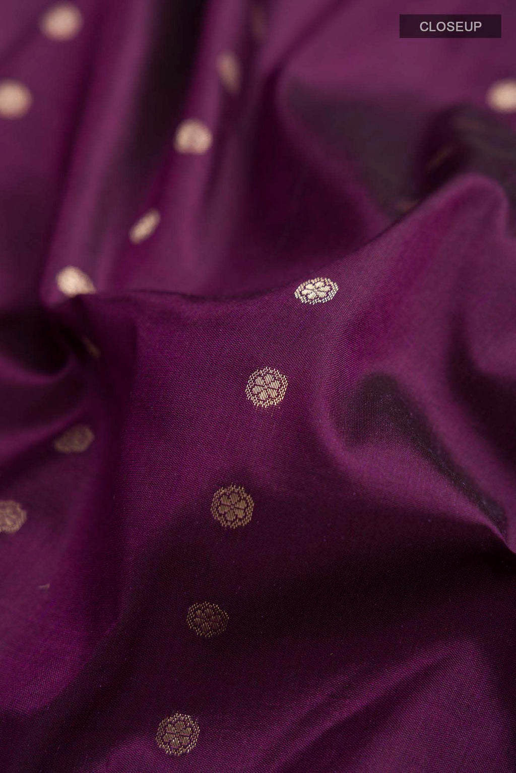 Close up of Violet Banarasi Katan Silk Saree with Zari Butta on the body and Zari Border displaying folds