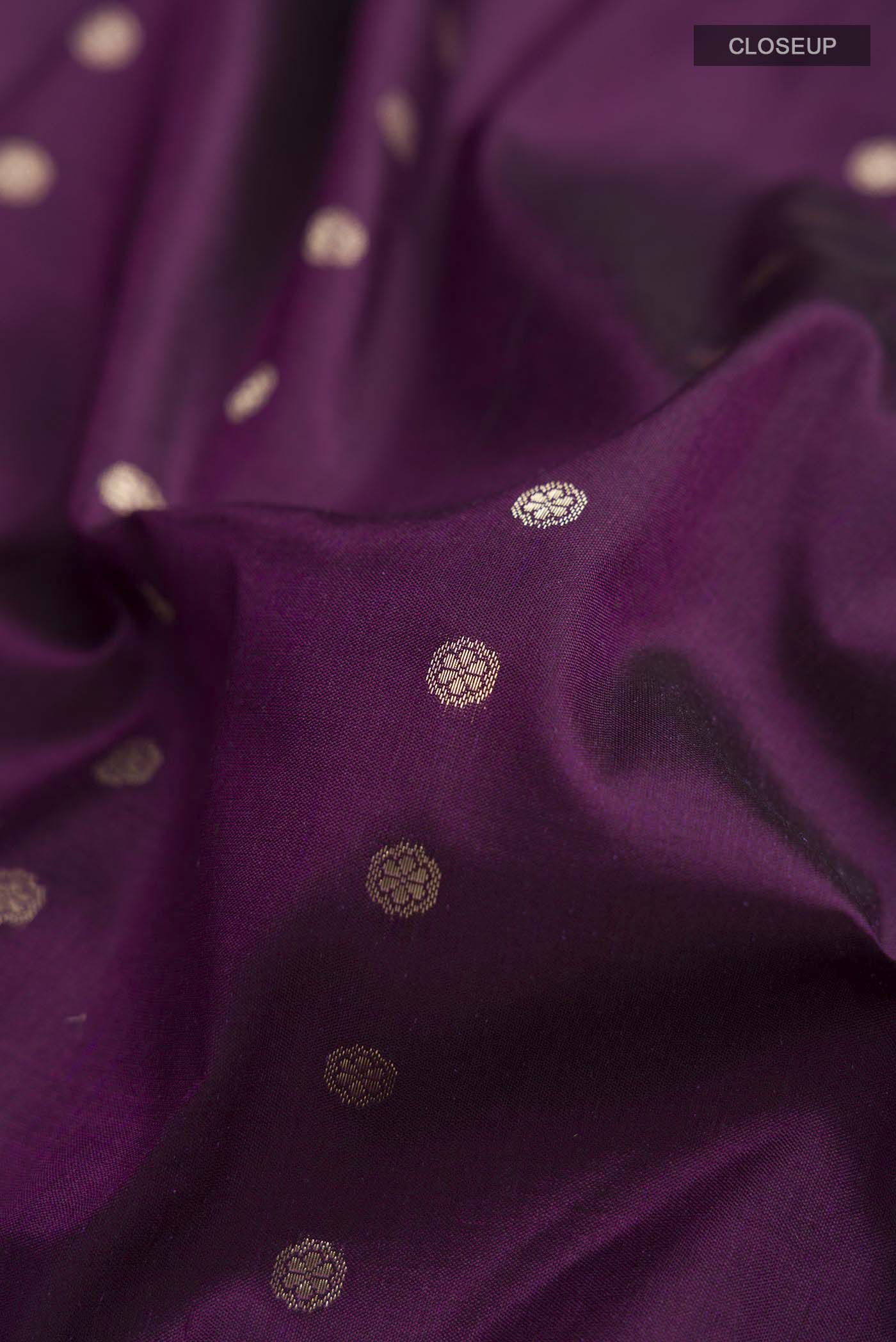 Close up of Violet Banarasi Katan Silk Saree with Zari Butta on the body and Zari Border displaying folds