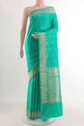 Sea Green Banarasi Silk Saree with Zari Butta on the body and Zari Border displayed on a mannequin
