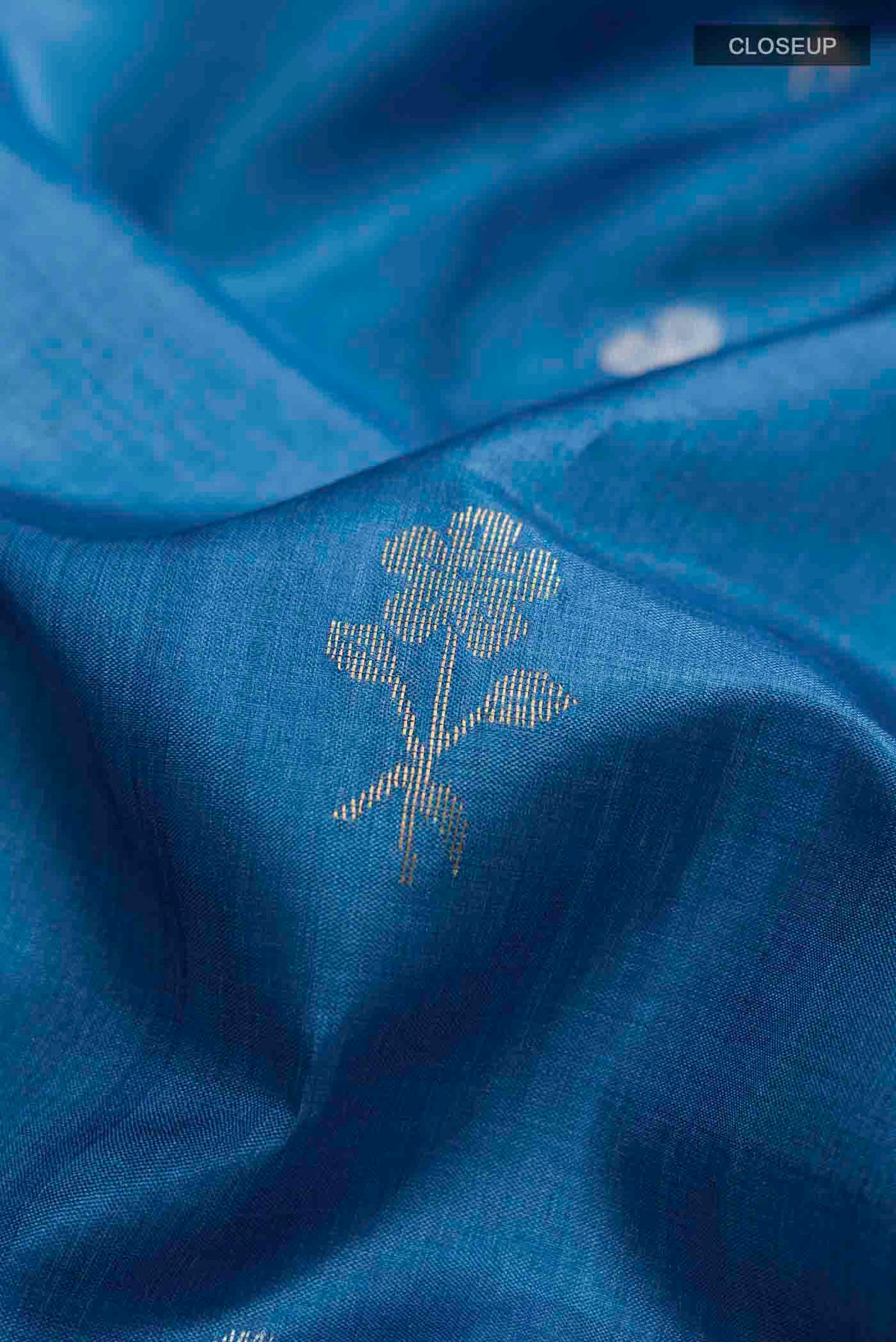 Close up of Blue Bhagalpuri Tussar Silk Saree with Zari Butta on the body and Zari Border displaying folds