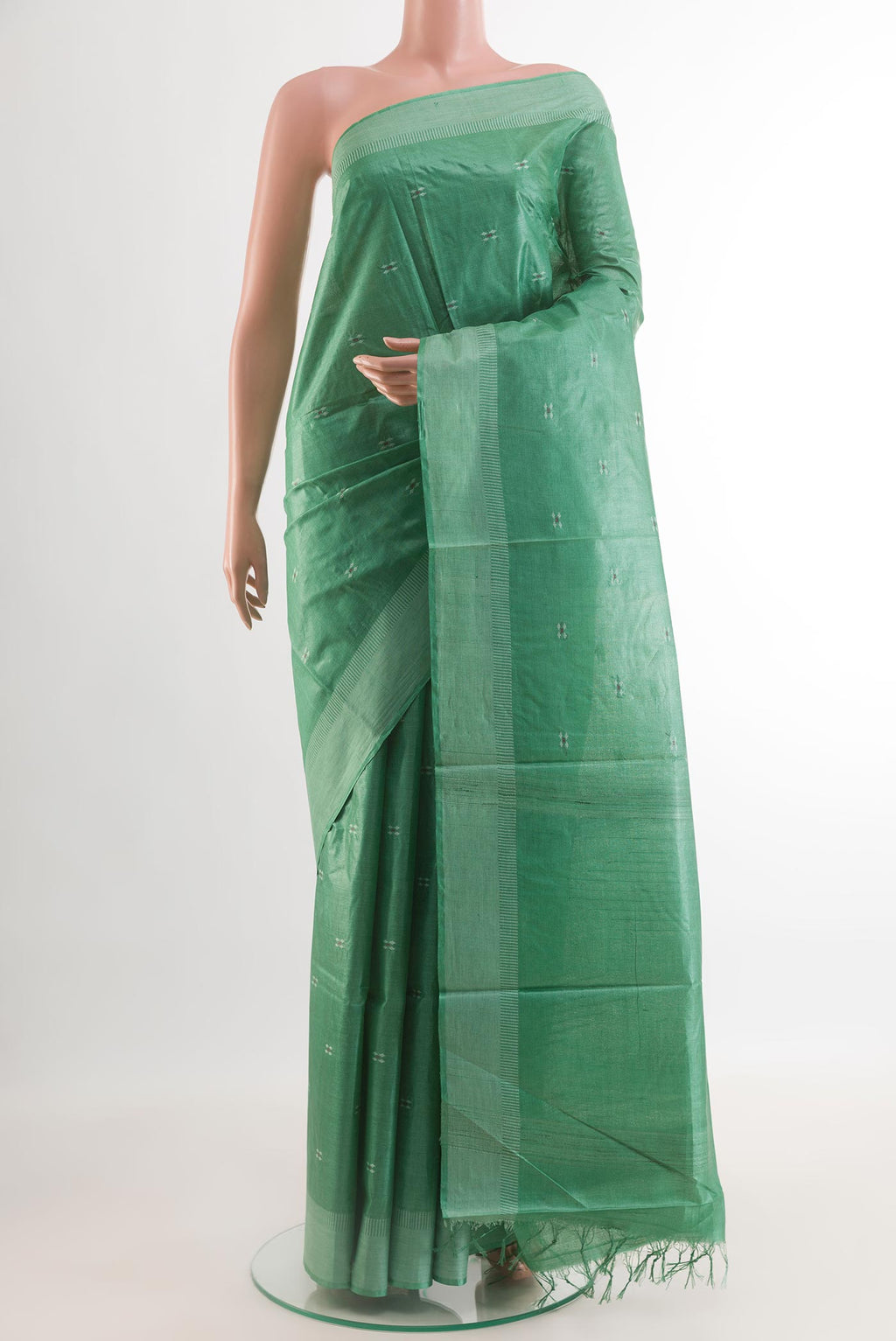 Sea Green Tussar Silk Saree with Thread Butta on the body and Zari Border.  displayed on a mannequin