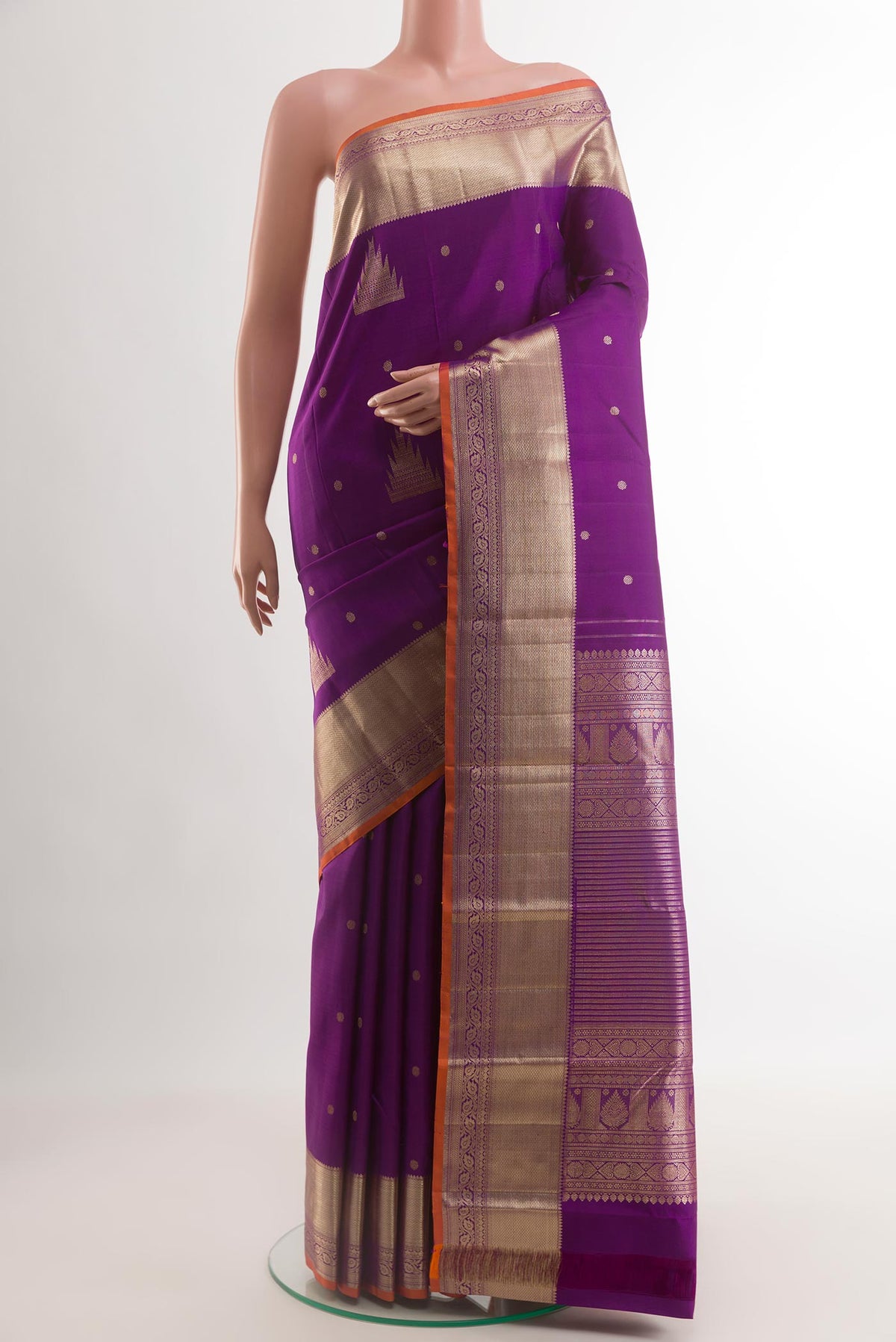 Purple Kanjivaram Silk Saree with Zari Butta on the body and Zari Border.  displayed on a mannequin
