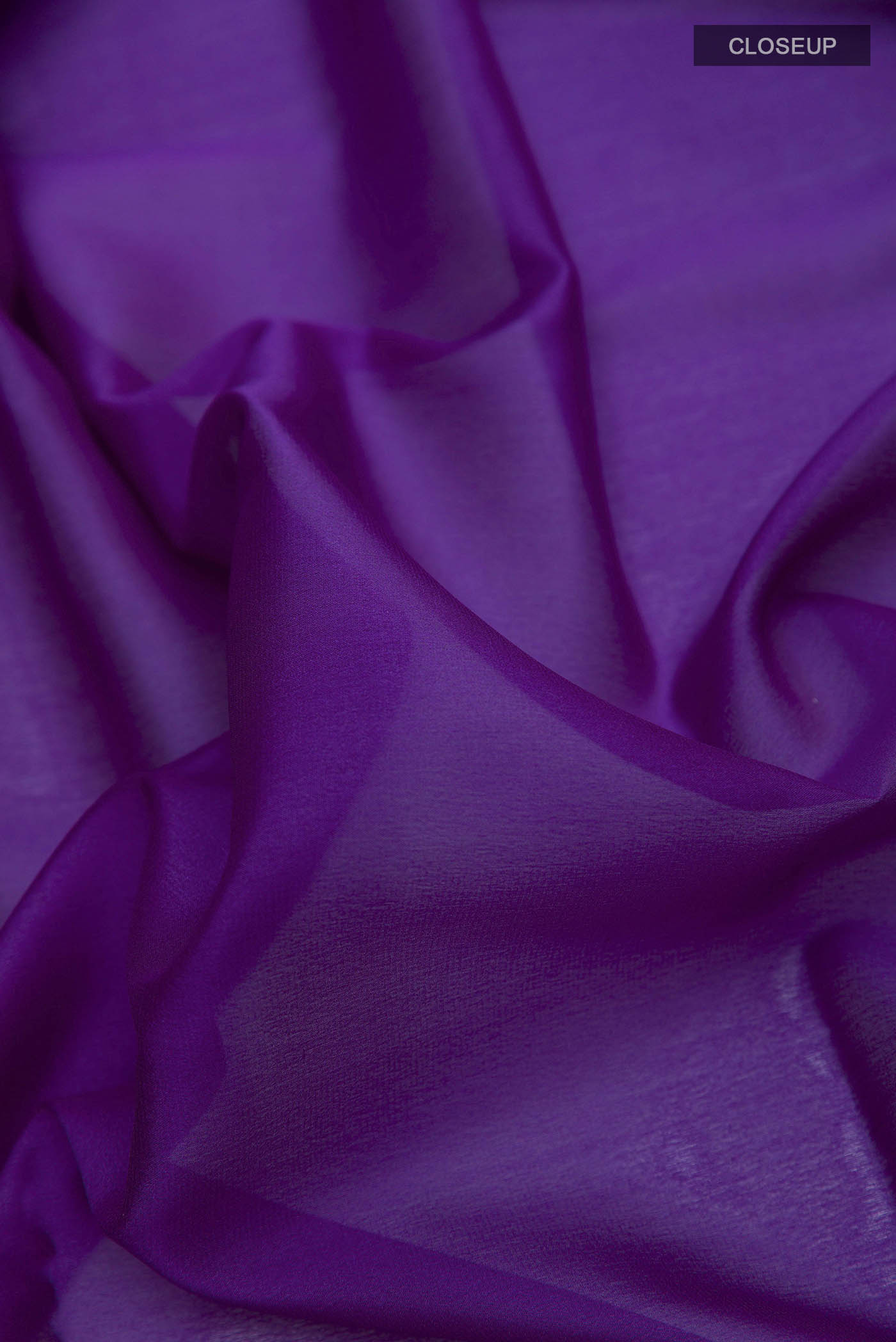 Close up of Purple Mysore Crepe Saree with Plain Body and Zari Border displaying folds
