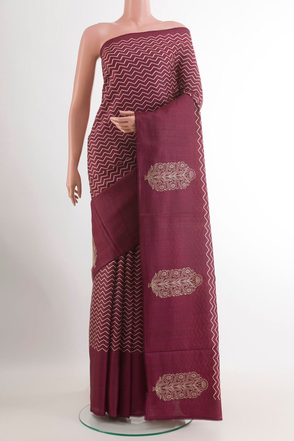 Magenta Tussar Saree with Printed design on the body and Zari Border.  displayed on a mannequin