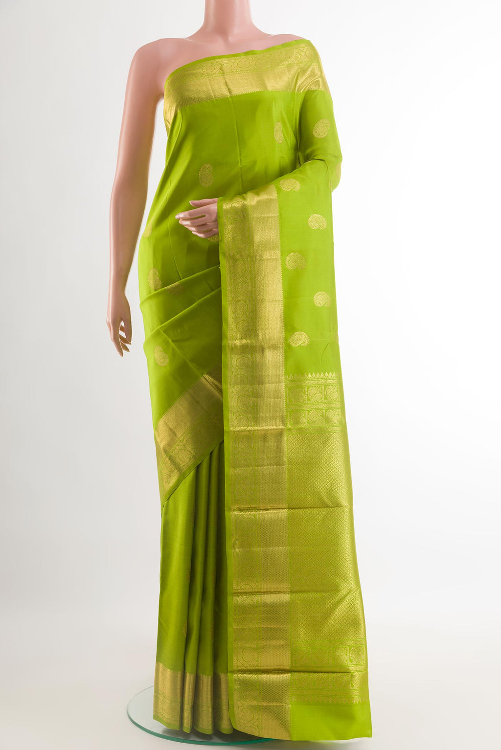 Green Kanjivaram Silk Saree with Zari Butta on the body and Zari Border.  displayed on a mannequin